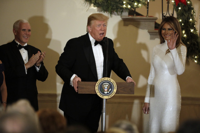 U.S. President Donald Trump speaks between First Lady Melania Trump and Vice President Mike Pence at the Congressional Ball at White House in Washington on December 15, 2018. (Photo by Yuri Gripas-Pool/Getty Images)