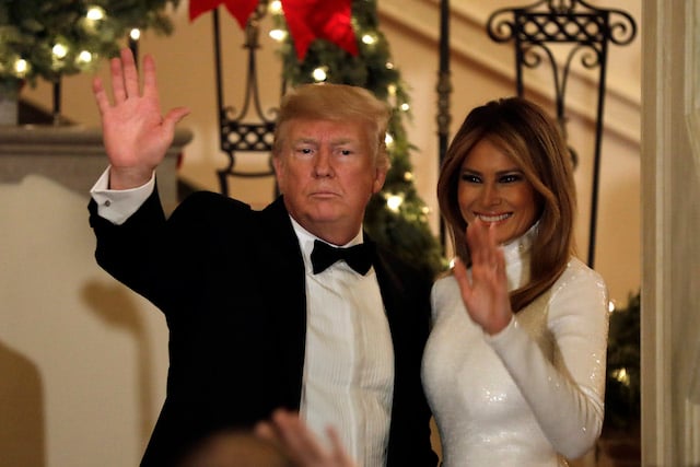 U.S. President Donald Trump and First Lady Melania Trump wave to the guests at the Congressional Ball at White House in Washington on December 15, 2018. (Photo by Yuri Gripas-Pool/Getty Images)