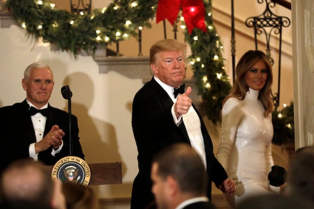 U.S. President Donald Trump with First Lady Melania Trump and Vice President Mike Pence (L) greet guests at the Congressional Ball at White House in Washington on December 15, 2018. (Photo by Yuri Gripas-Pool/Getty Images)