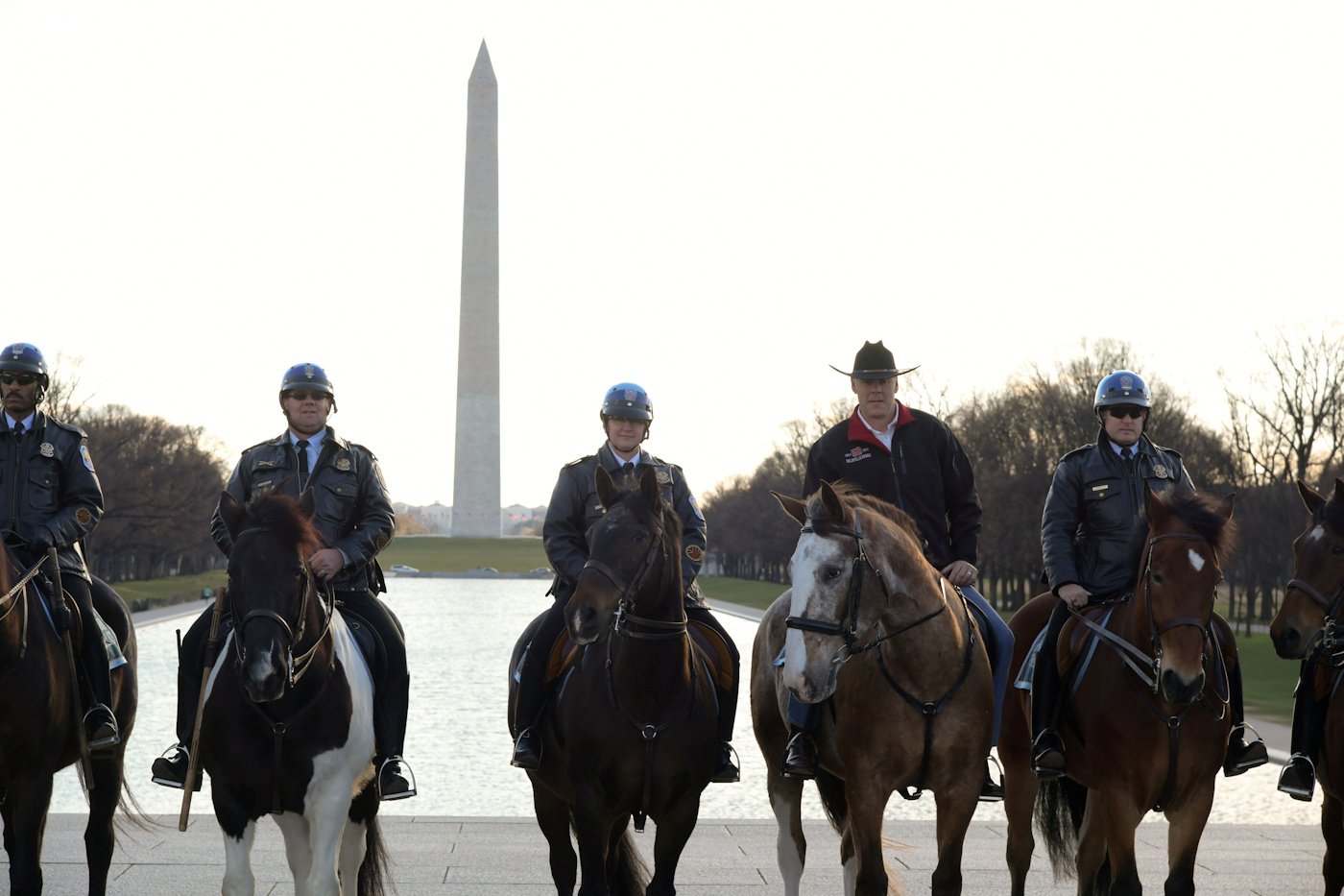Handout photo of new Interior Secretary Ryan Zinke (2nd from R) rides on horseback with a U.S. Park Police horse mounted unit while reporting for his first day of work at the Interior Department in Washington