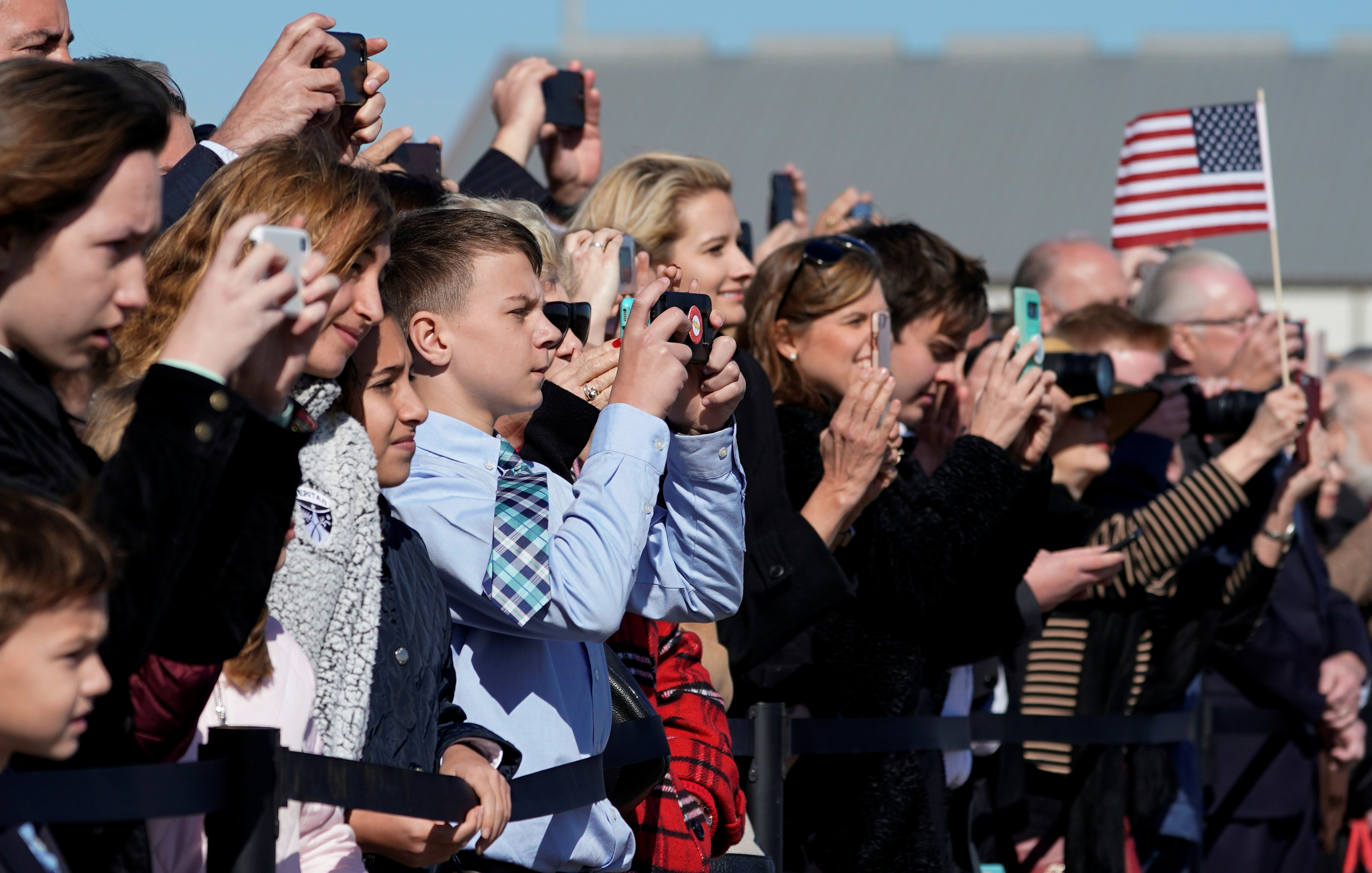 People watch the departure ceremony for the late former U.S. President George H.W. Bush at Ellington Field in Houston, Texas, U.S., December 3, 2018. (David J. Phillip/Pool via REUTERS)
