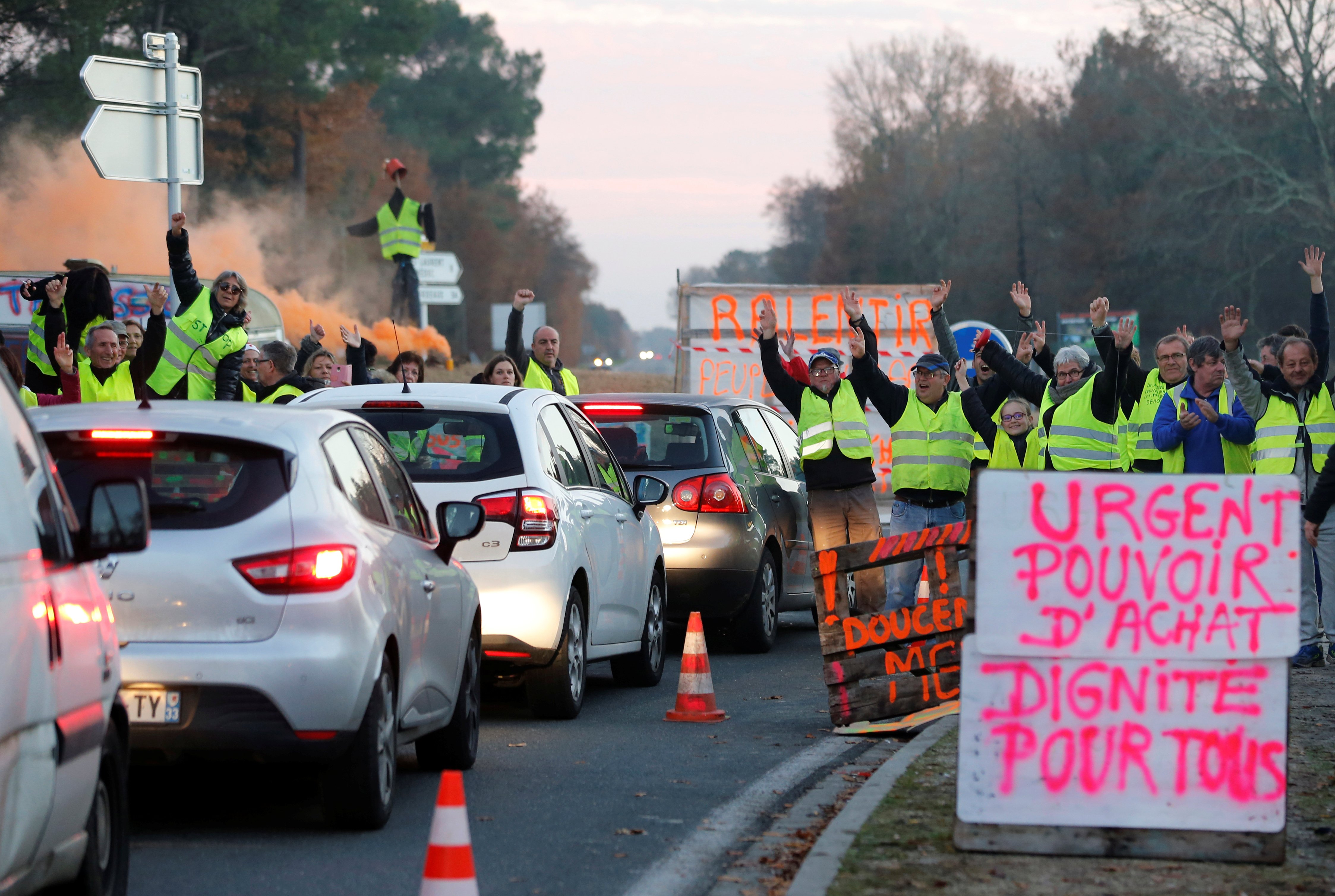 Protesters wearing yellow vests, the symbol of a French drivers' protest against higher diesel fuel prices, occupy a roundabout in Cissac-Medoc
