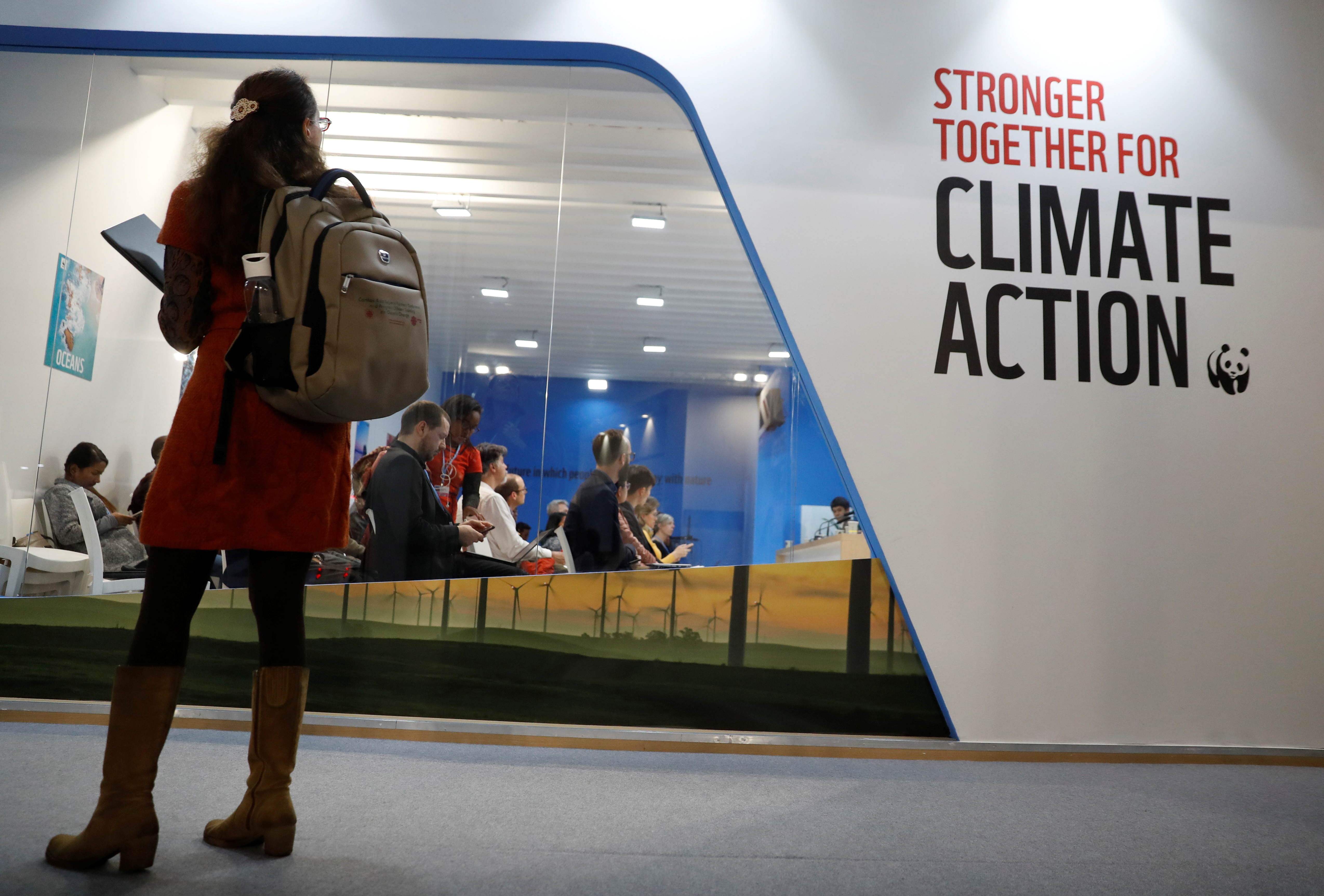 A woman watches an exhibition inside the venue of the COP24 U.N. Climate Change Conference 2018 in Katowice