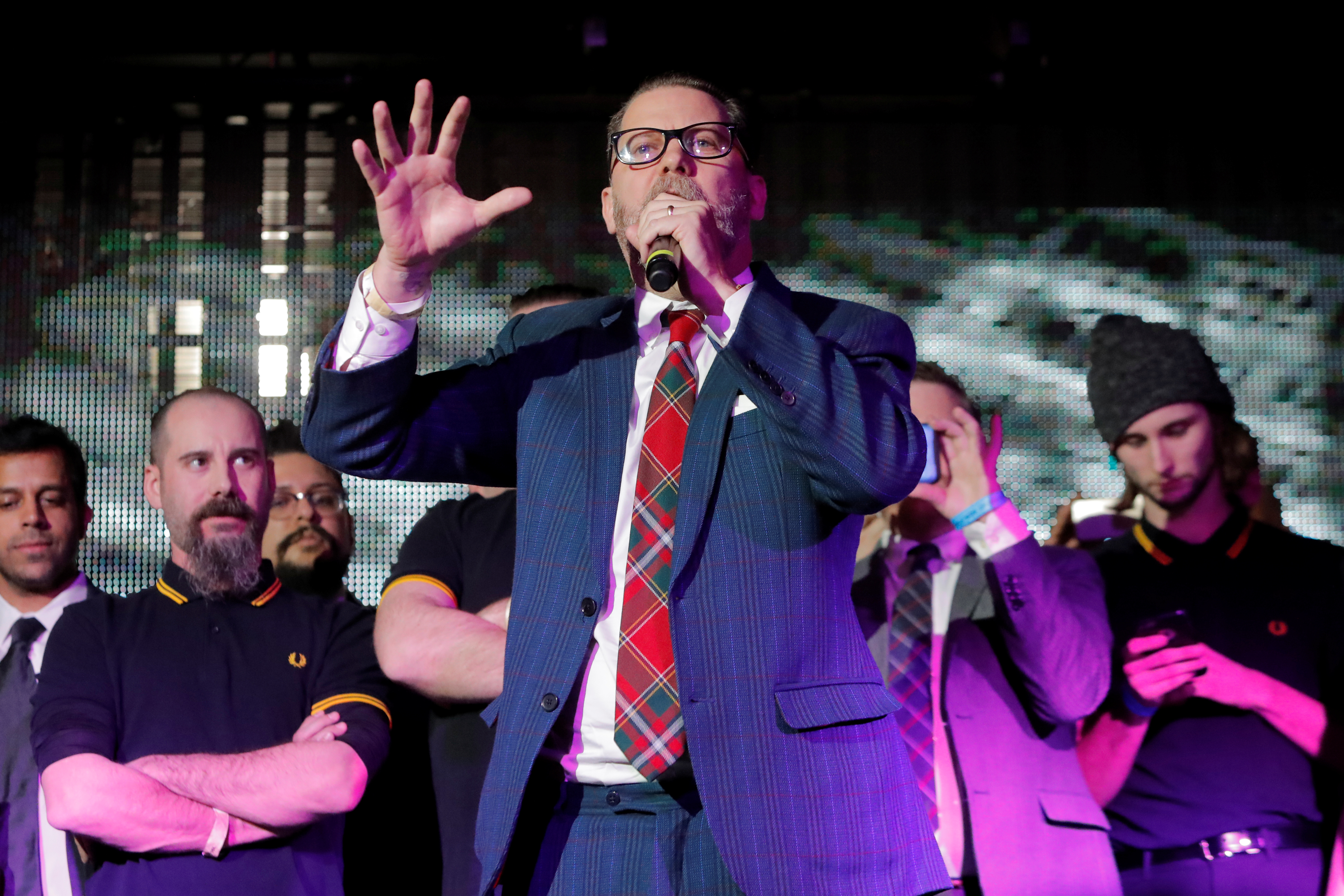 Vice magazine co-founder Gavin McInnes speaks on stage with members of the Proud Boys organization at the "A Night for Freedom" event organized by Mike Cernovich, in Manhattan, New York, U.S., January 20, 2018. REUTERS/Andrew Kelly - RC11C4A4AE40