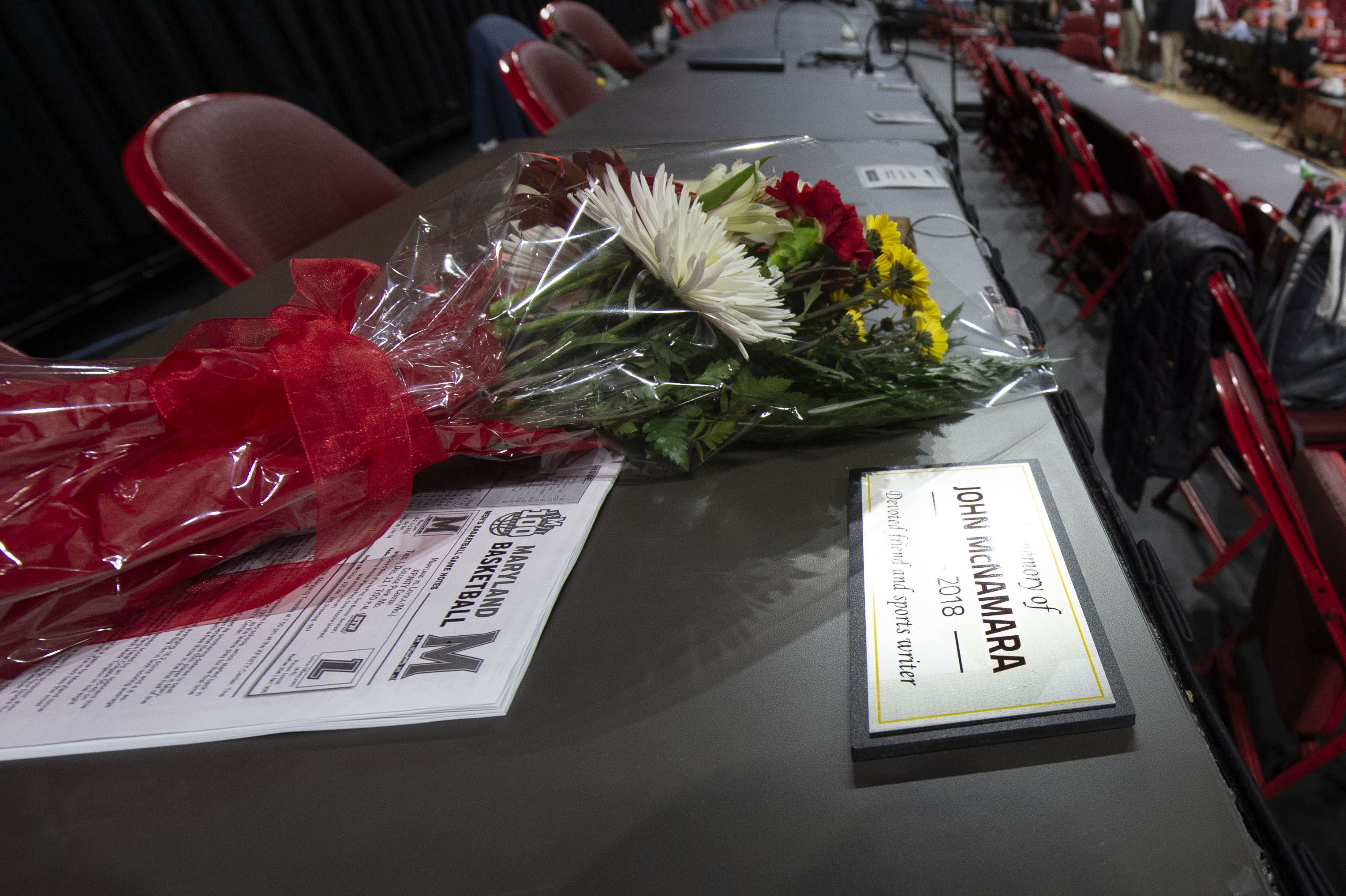 Dec 11, 2018; College Park, MD, USA; A memorial for Capital Gazette journalist John McNamara, who was killed in a mass shooting in a news room earlier this year, sits on press room before the game between the Maryland Terrapins and the Loyola (Md) Greyhounds at XFINITY Center. Mandatory Credit: Tommy Gilligan-USA TODAY Sports - 11829142