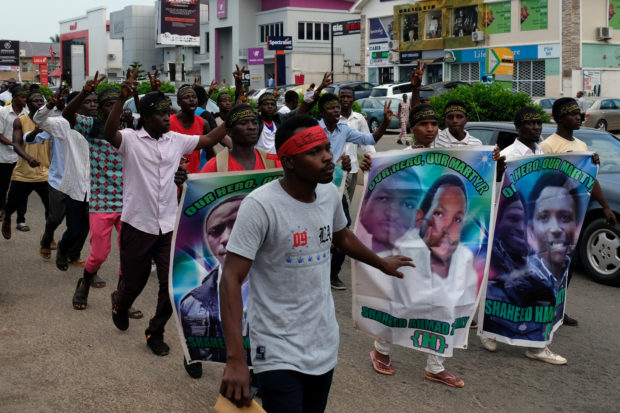 Members of the Islamic Movement of Nigeria gesture during a march to demand the release of their Nigerian Shi'ite leader Ibrahim Zakzaky, along a street in Abuja, Nigeria October 31, 2018. REUTERS/Paul Carsten