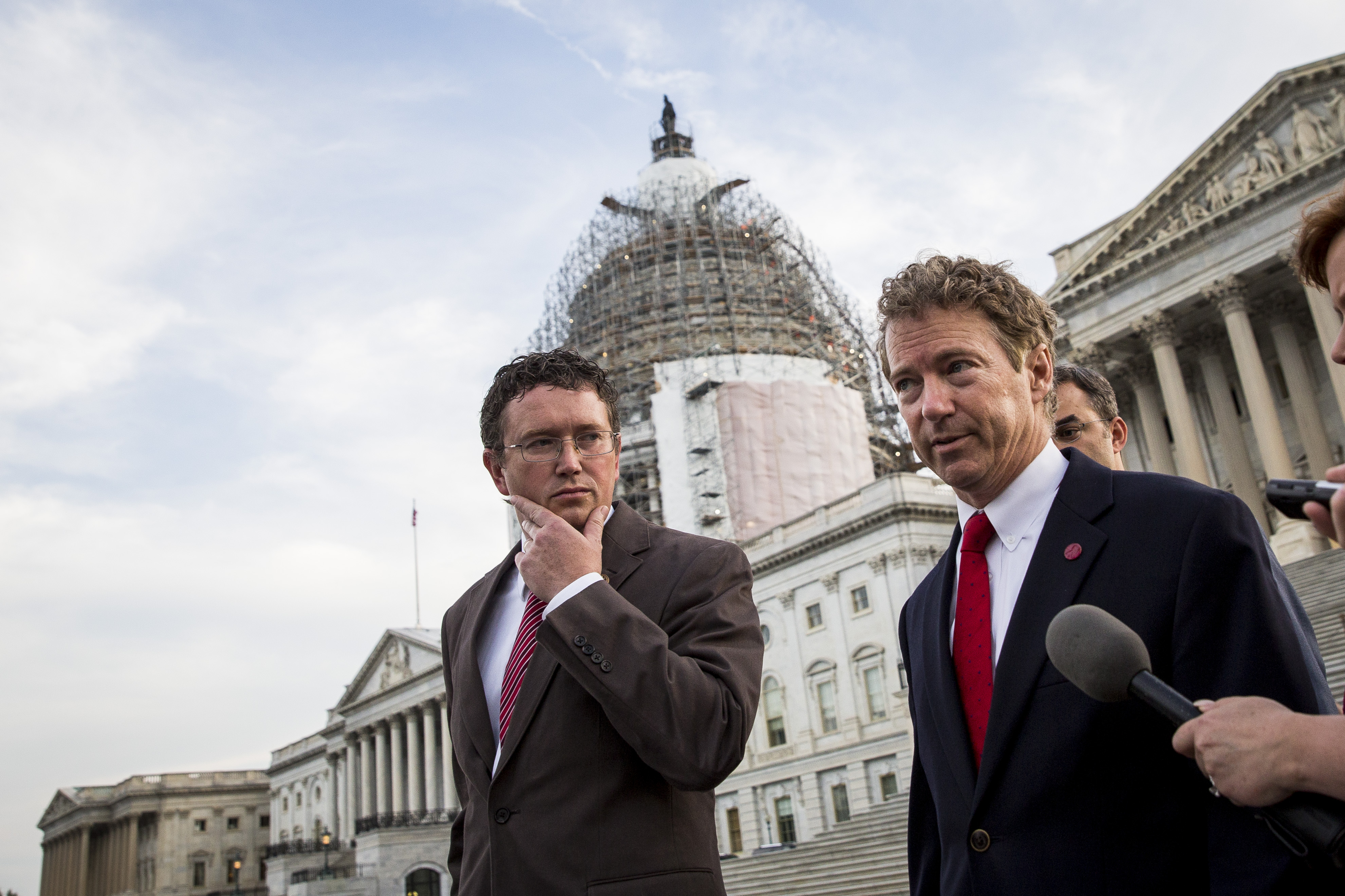 Rep. Thomas Massie listens as Sen. Rand Paul speaks to reporters after exiting the Senate chamber, on Capitol Hill, (Drew Angerer/Getty Images)