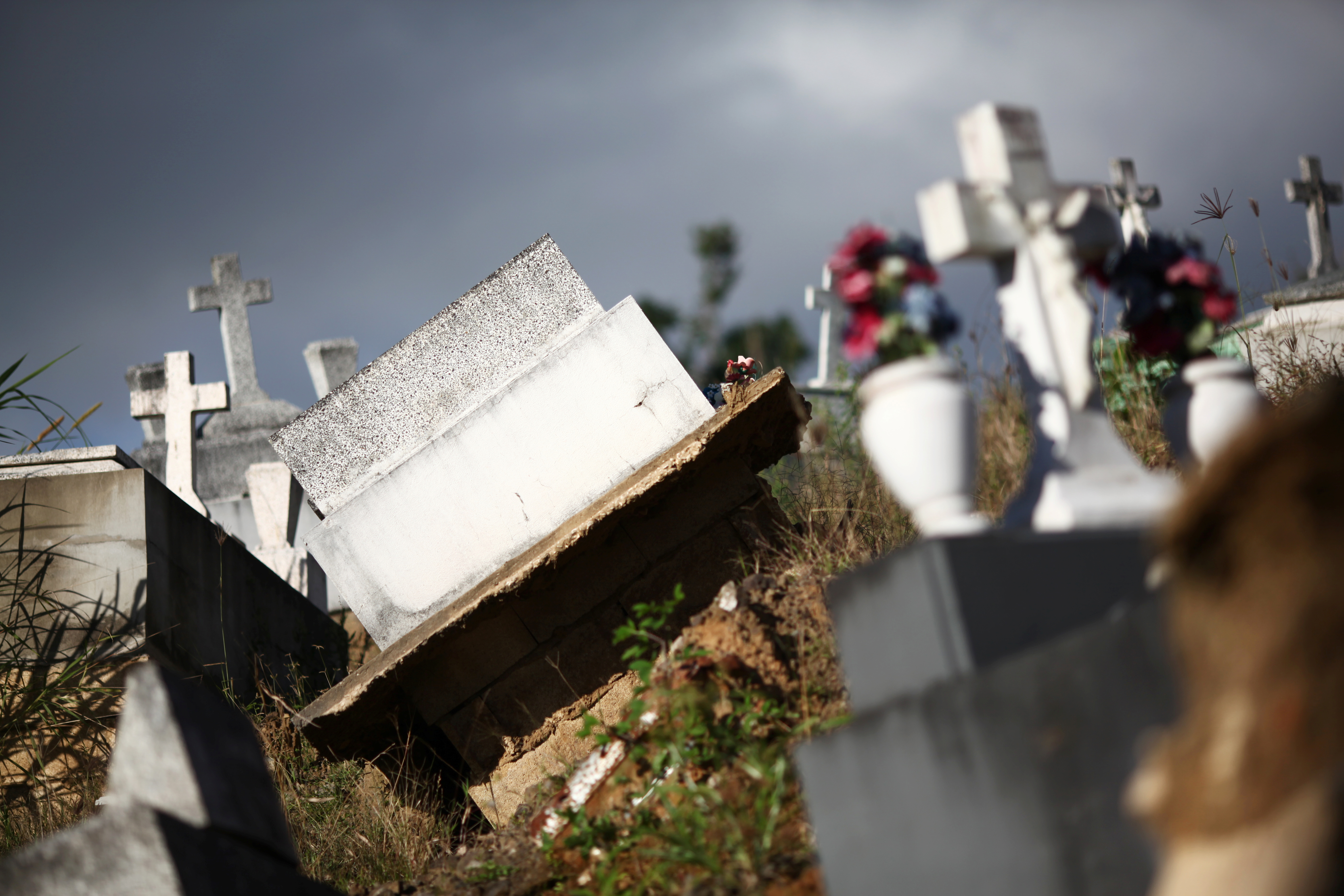 Graves destroyed during Hurricane Maria in September 2017, are seen at a cemetery, in Lares, Puerto Rico February 8, 2018. Picture taken February 8, 2018. REUTERS/Alvin Baez