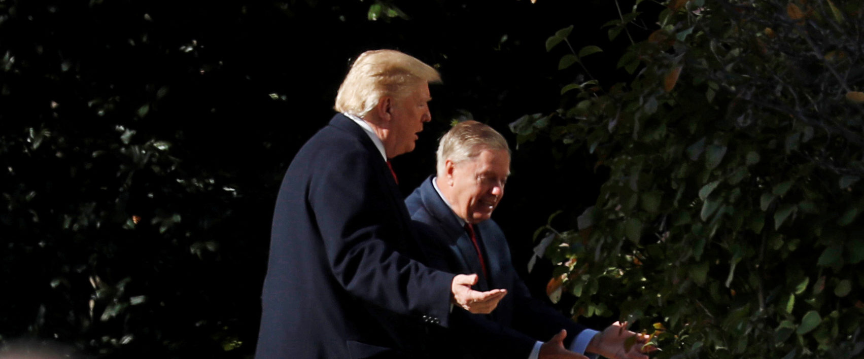 U.S. President Donald Trump walks with Sen. Lindsey Graham (R-SC) upon Trump's return from the Supreme Court to the White House in Washington, U.S., November 8, 2018. REUTERS/Kevin Lamarque