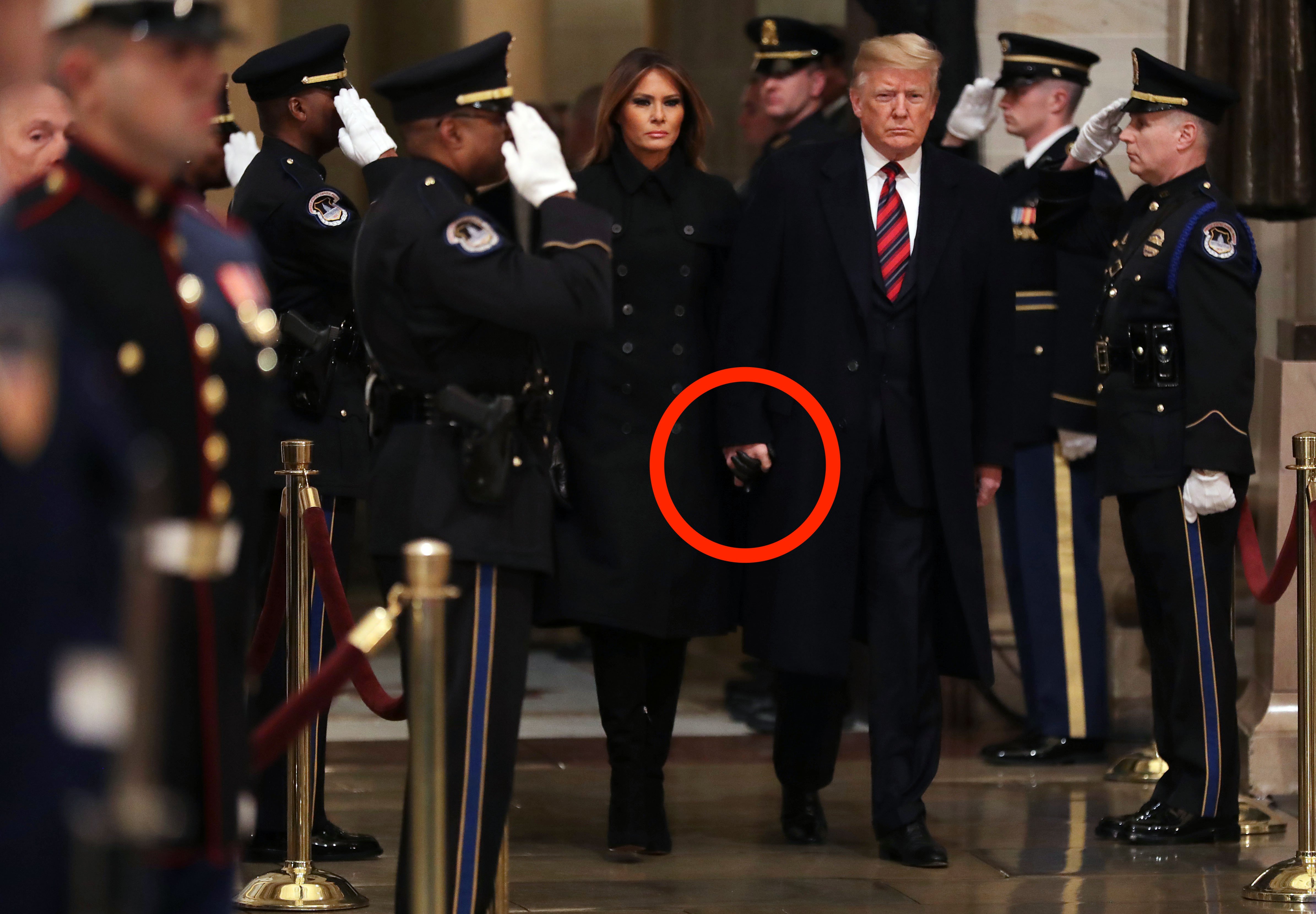 WASHINGTON, DC - DECEMBER 03: U.S. President Donald Trump and first lady Melania Trump arrive in the U.S. Capitol Rotunda to pay their respects as former U.S. President George H.W. Bush lies in state December 03, 2018 in Washington, DC. A WWII combat veteran, Bush served as a member of Congress from Texas, ambassador to the United Nations, director of the CIA, vice president and 41st president of the United States. Members of the public can pay their respects as Bush lays in state until Wednesday, when he will be honored during a memorial service at the National Cathedral. Chip Somodevilla/Getty Images