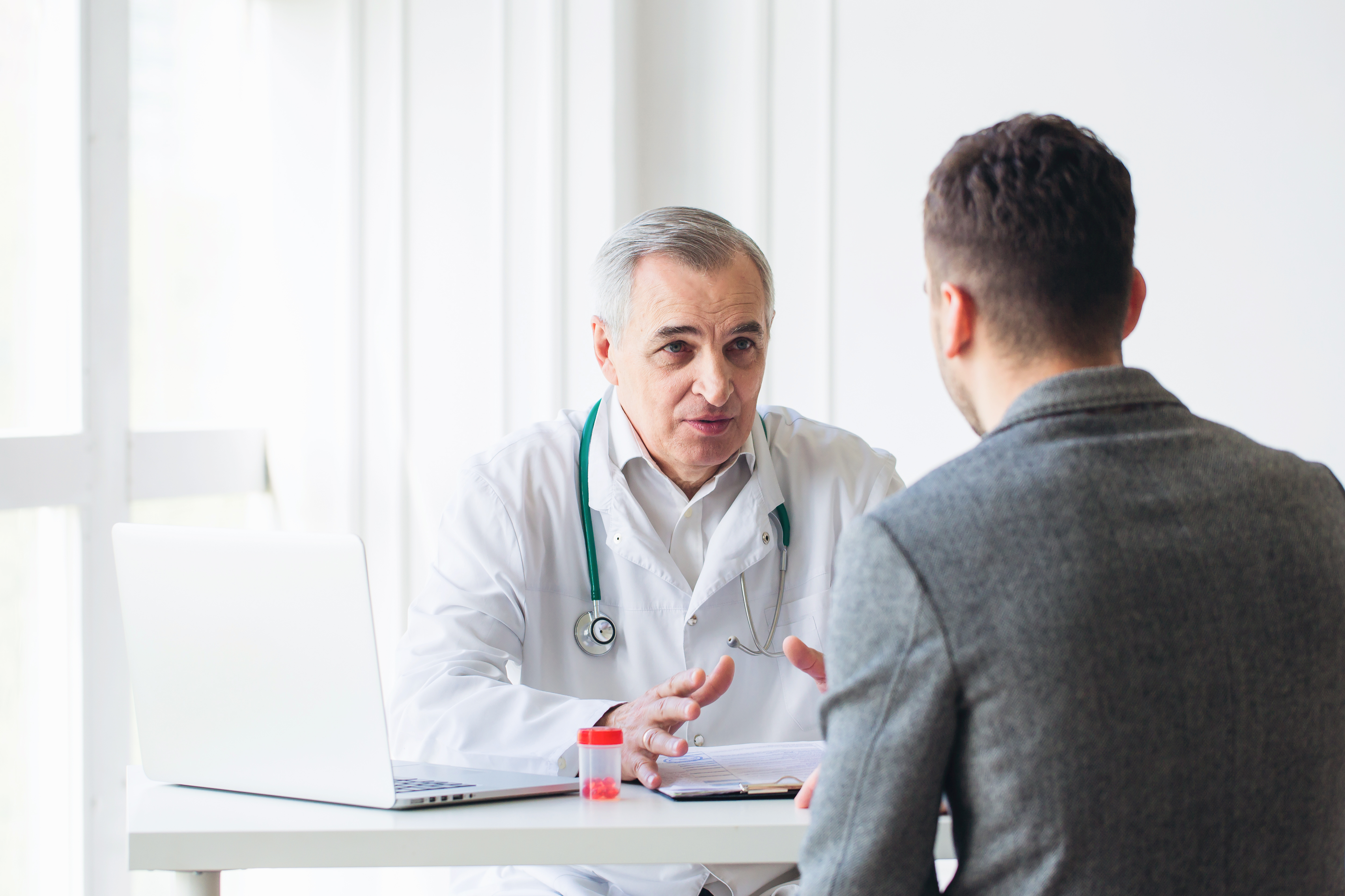 A doctor consults with a patient. Shutterstock image via user uzhursky