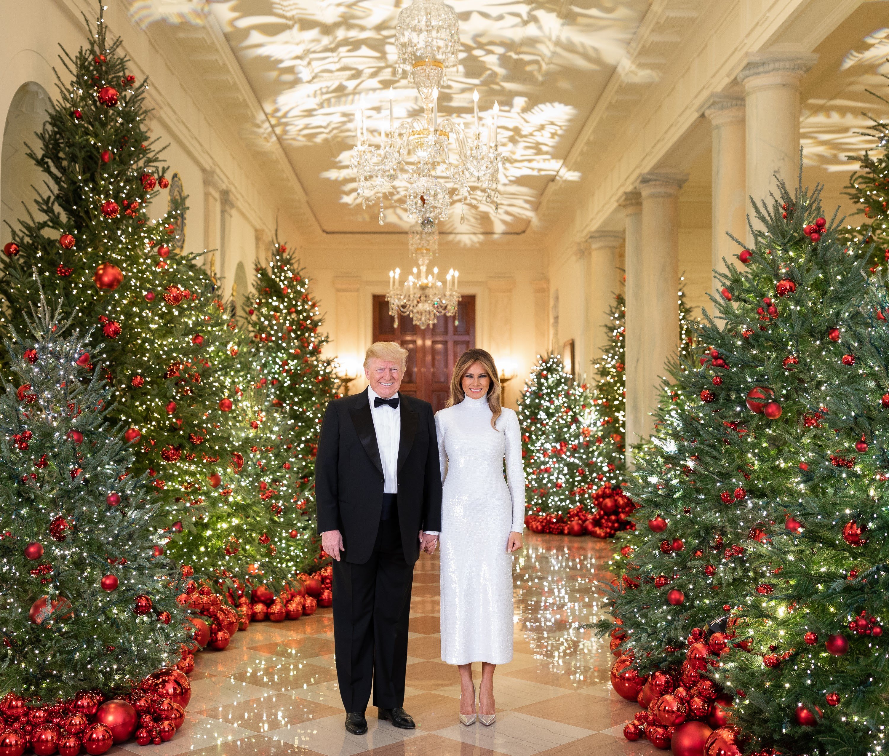 President Donald J. Trump and First Lady Melania Trump are seen in their Official Christmas Portrait on Saturday, December 15, 2018, in the Cross Hall of the White House in Washington, D.C. (Official White House Photo by Andrea Hanks)
