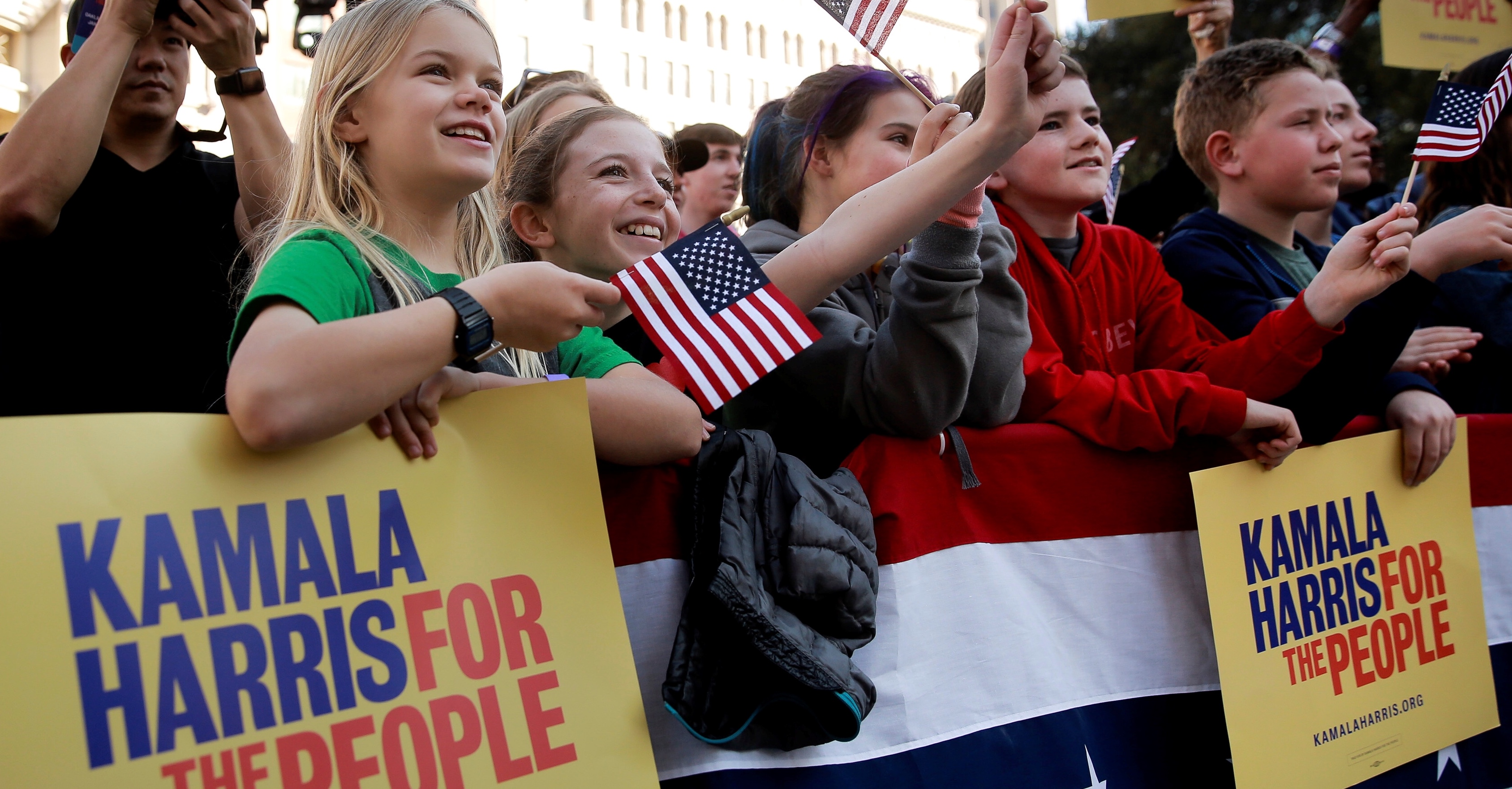 Nora Baedeker, 11, and Maggie Sinclair,12, listen to U.S. Senator Kamala Harris speak at the launch of her campaign for President of the United States at a rally at Frank H. Ogawa Plaza in her hometown of Oakland, California, U.S., January 27, 2019. REUTERS/Elijah Nouvelage - RC1A73D1B970