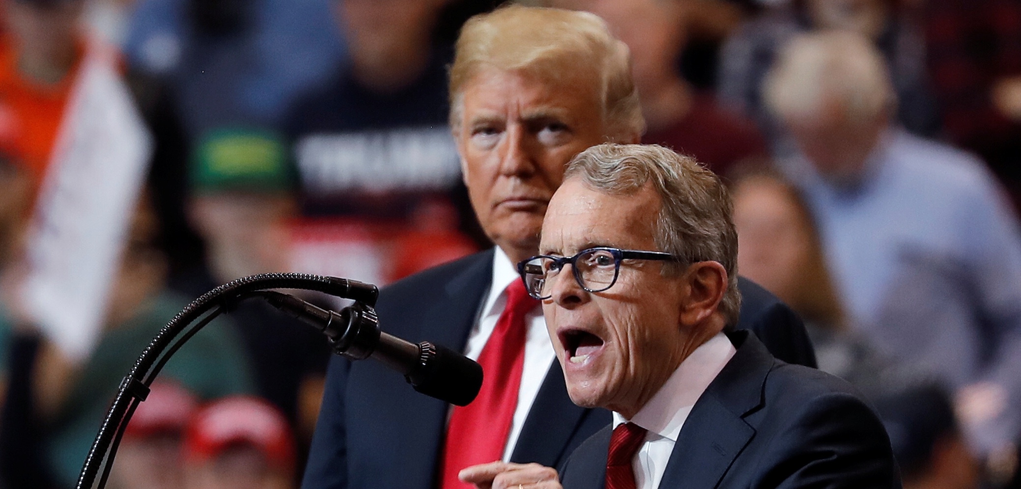 U.S. President Donald Trump listens as Ohio gubernatorial nominee and Ohio Attorney General Mike Dewine speaks during a campaign rally in Cleveland, Ohio., U.S., November 5, 2018. REUTERS/Carlos Barria