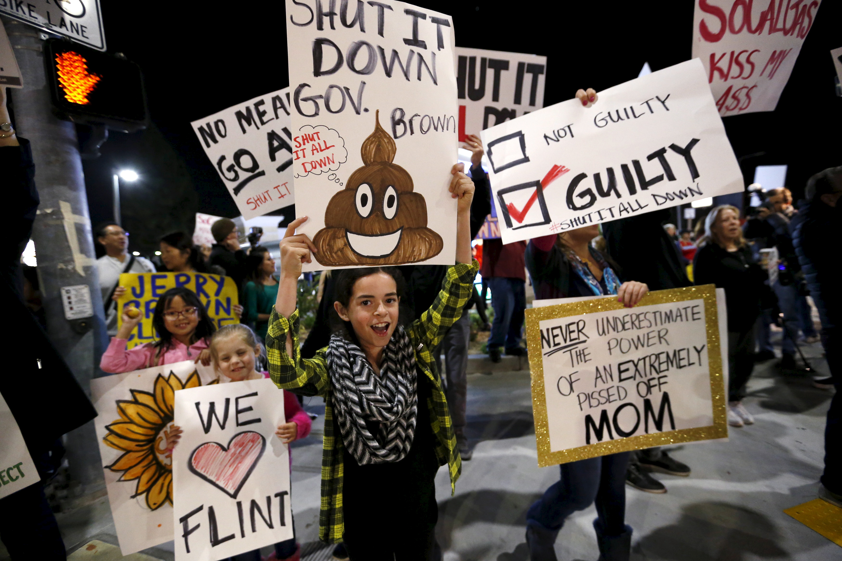 People hold signs as they rally for the permanent shut down of the Aliso Canyon natural gas storage facility near the Porter Ranch neighborhood in Los Angeles, California February 19, 2016. REUTERS/Mario Anzuoni