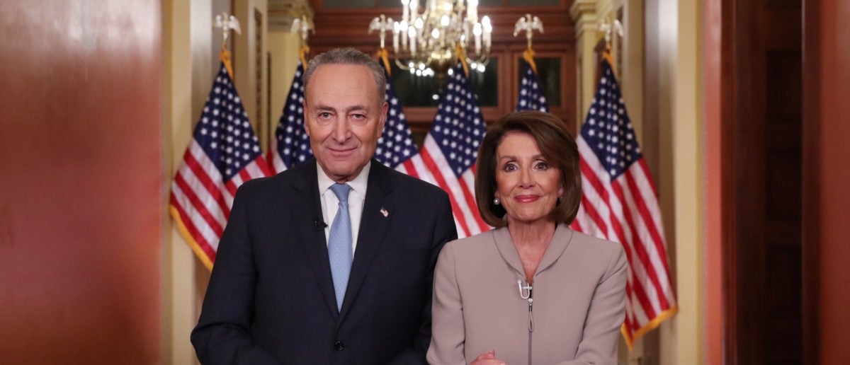 U.S. Speaker of the House Nancy Pelosi and Senate Minority Leader Chuck Schumer pose for photographers after concluding their joint response, to President Trump's prime time address, on Capitol Hill in Washington, U.S., January 8, 2019. REUTERS/Jonathan Ernst