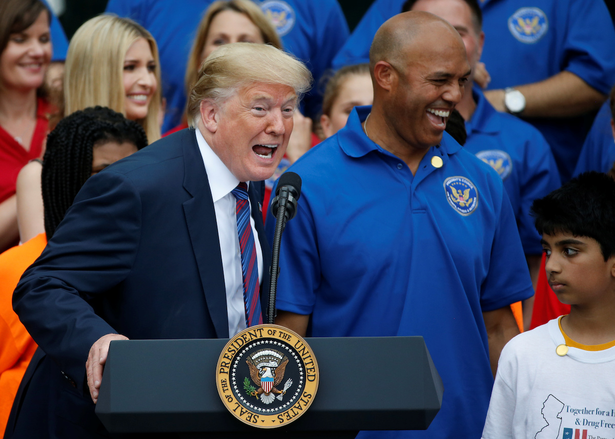 U.S. President Donald Trump laughs with former New York Yankees pitcher Mariano Rivera as he delivers remarks at the White House Sports and Fitness Day event on the South Lawn of the White House in Washington, U.S., May 30, 2018. REUTERS/Leah Millis 