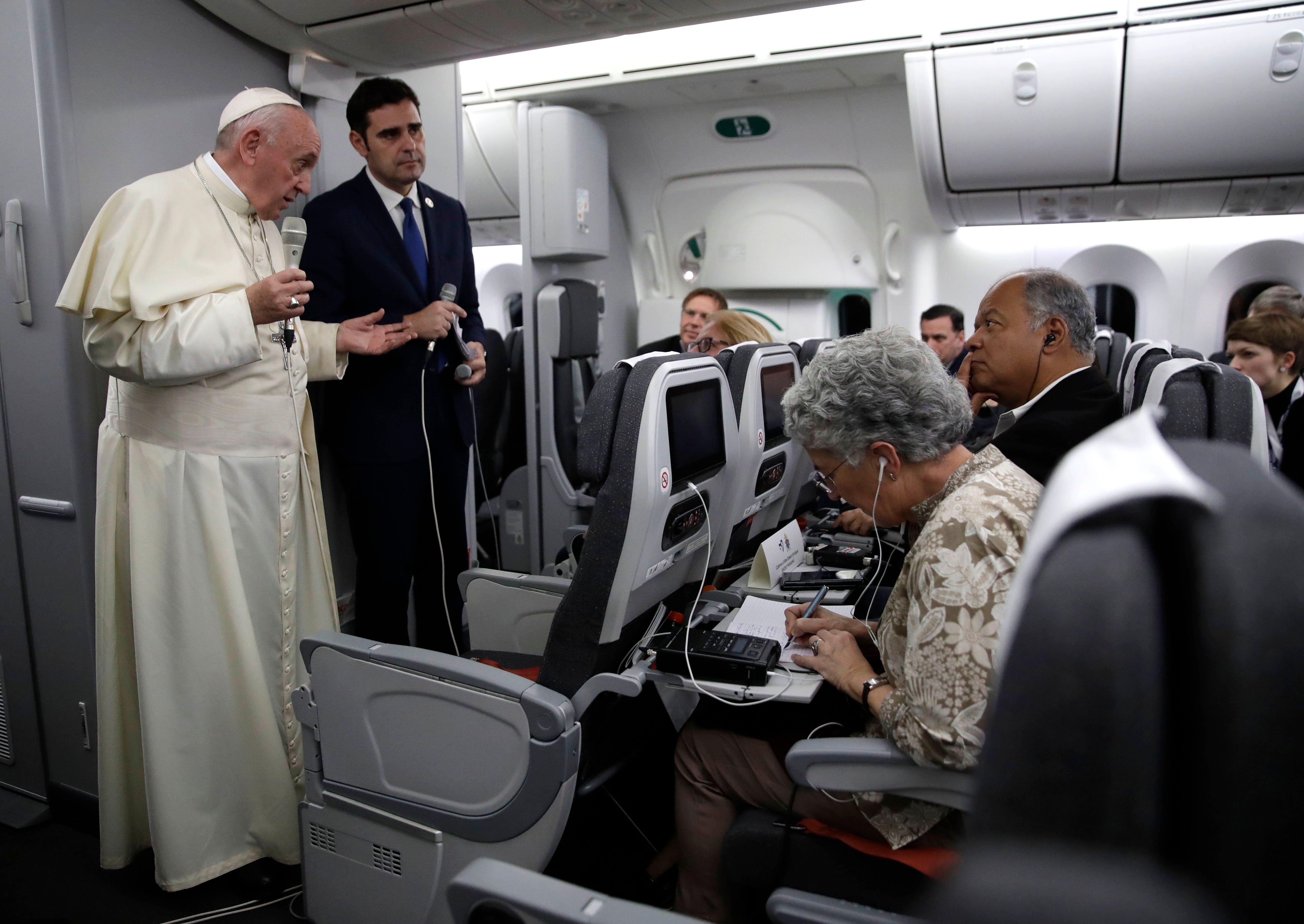 Pope Francis, flanked by Vatican spokesman Alessandro Gisotti (R) anwers journalists questions in the plane following the take off from Panama City on January 27, 2019 after participating in World Youth Day. (ALESSANDRA TARANTINO/AFP/Getty Images)