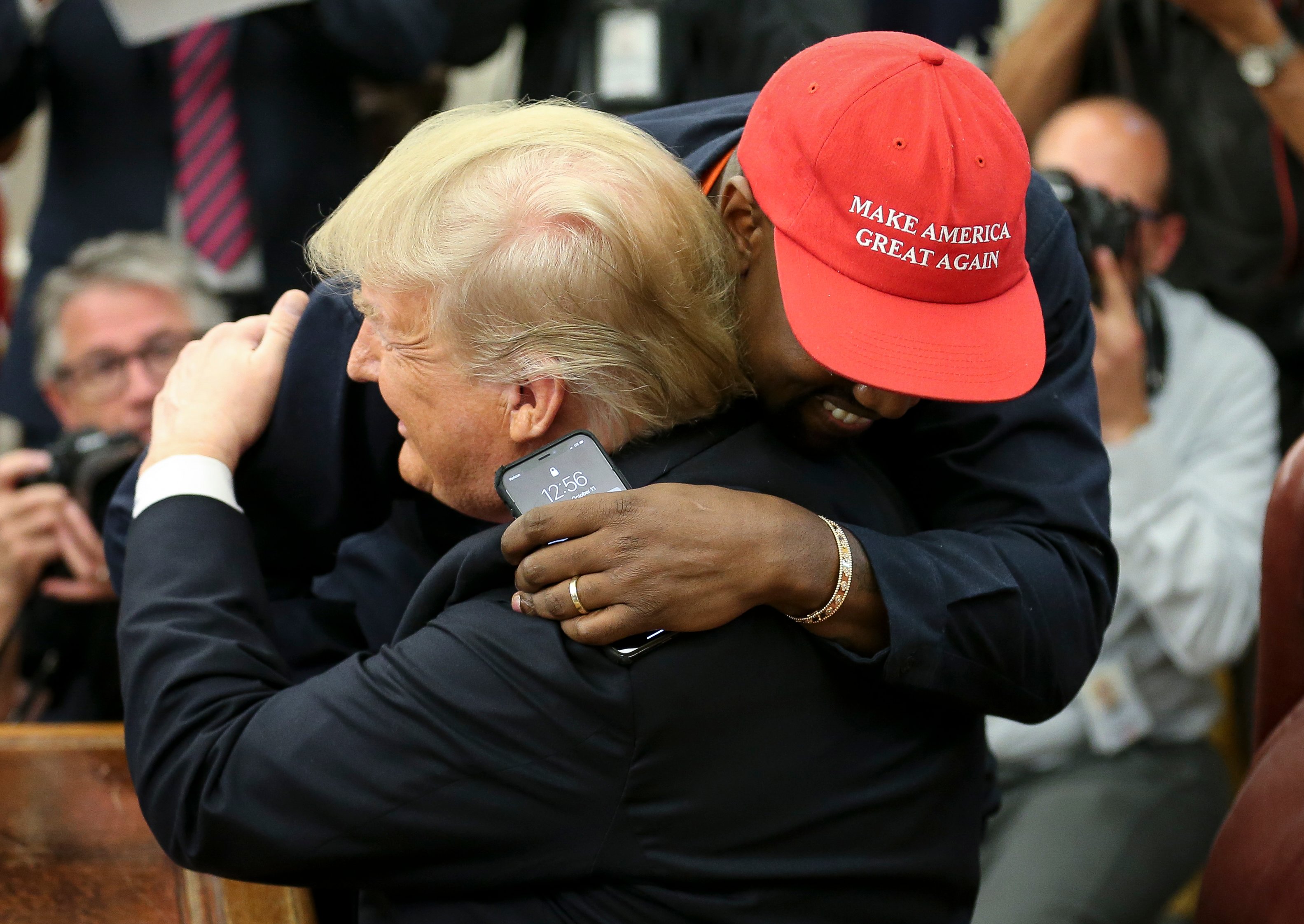 U.S. President Donald Trump hugs rapper Kanye West during a meeting in the Oval office of the White House on October 11, 2018 in Washington, DC. (Photo by Oliver Contreras - Pool/Getty Images)