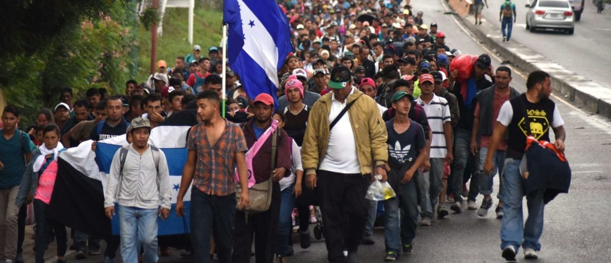 TOPSHOT - Honduran migrants take part in a caravan towards the United States in Chiquimula, Guatemala on October 17, 2018. - A migrant caravan set out on October 13 from the impoverished, violence-plagued country and was headed north on the long journey through Guatemala and Mexico to the US border. President Donald Trump warned Honduras he will cut millions of dollars in aid if the group of about 2,000 migrants is allowed to reach the United States. (Photo by ORLANDO ESTRADA / AFP) (Photo credit should read ORLANDO ESTRADA/AFP/Getty Images)