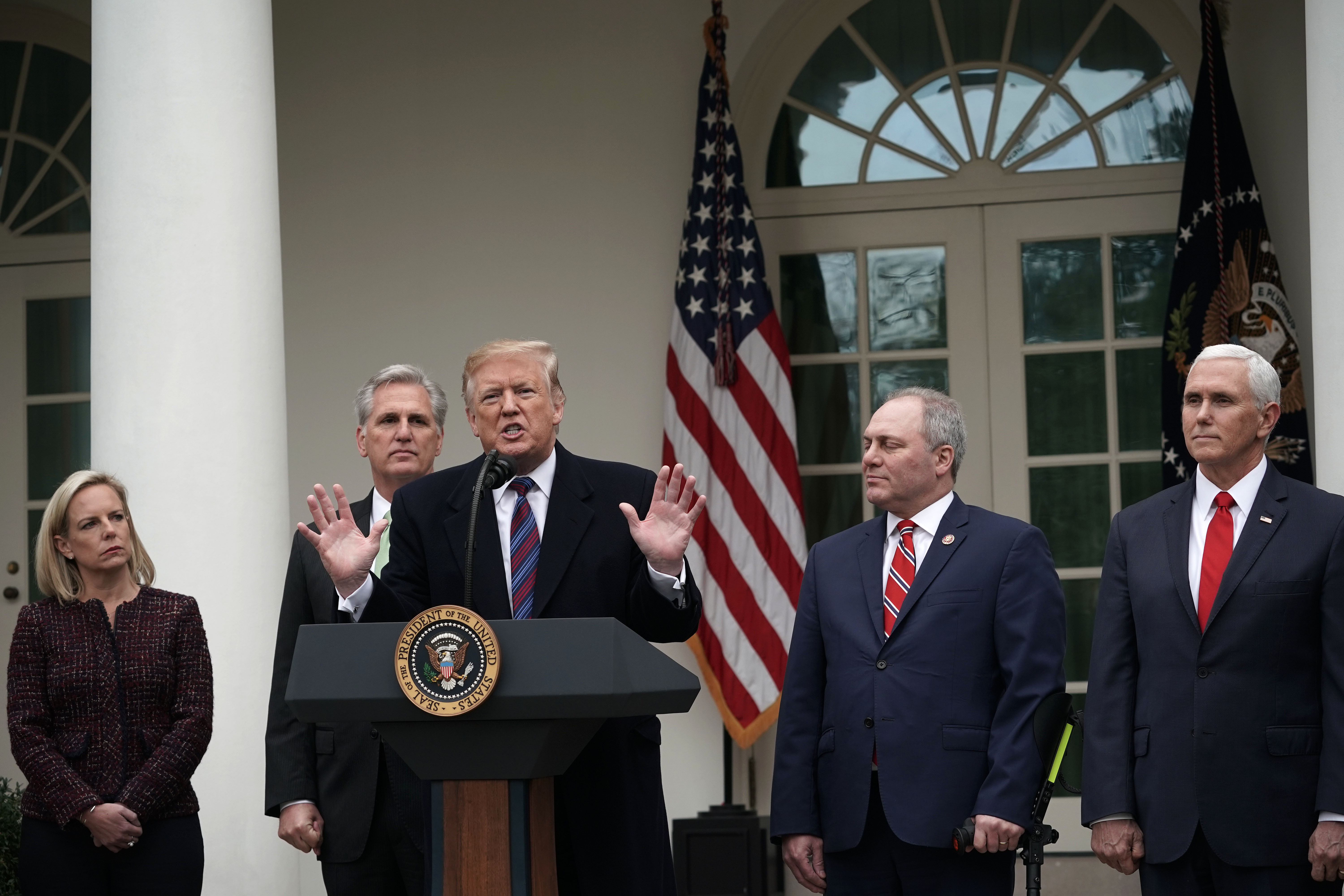 U.S. President Donald Trump (3rd L) speaks as Secretary of Homeland Security Kirstjen Nielsen (L), Vice President Mike Pence (R), House Minority Whip Rep. Steve Scalise (4th L) and House Minority Leader Rep. Kevin McCarthy (2nd L) listen in the Rose Garden of the White House on January 4, 2019 in Washington, DC. (Photo by Alex Wong/Getty Images)