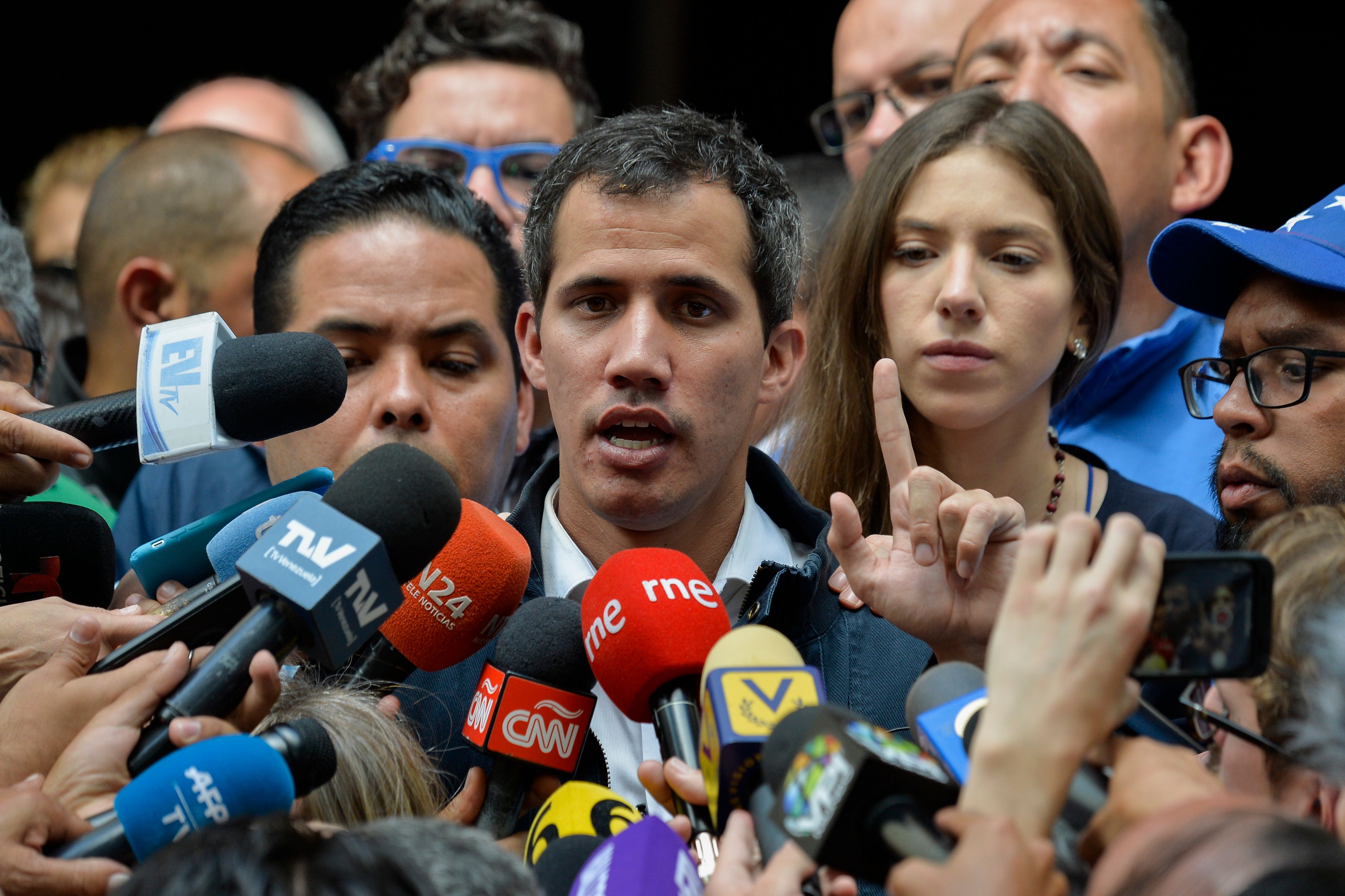 Venezuela's National Assembly head and self-proclaimed "acting president" Juan Guaido speaks to the press after attending a mass in honour to the fallen in the fight for freedom, political prisoners and the exiled, at the San Jose church in Caracas on January 27, 2019. - Guaido, who has galvanized a previously divided opposition, is offering an amnesty approved by the opposition-controlled National Assembly to anyone in the military who disavows President Nicolas Maduro, even suggesting amnesty for Maduro himself. (Photo by LUIS ROBAYO/AFP/Getty Images)