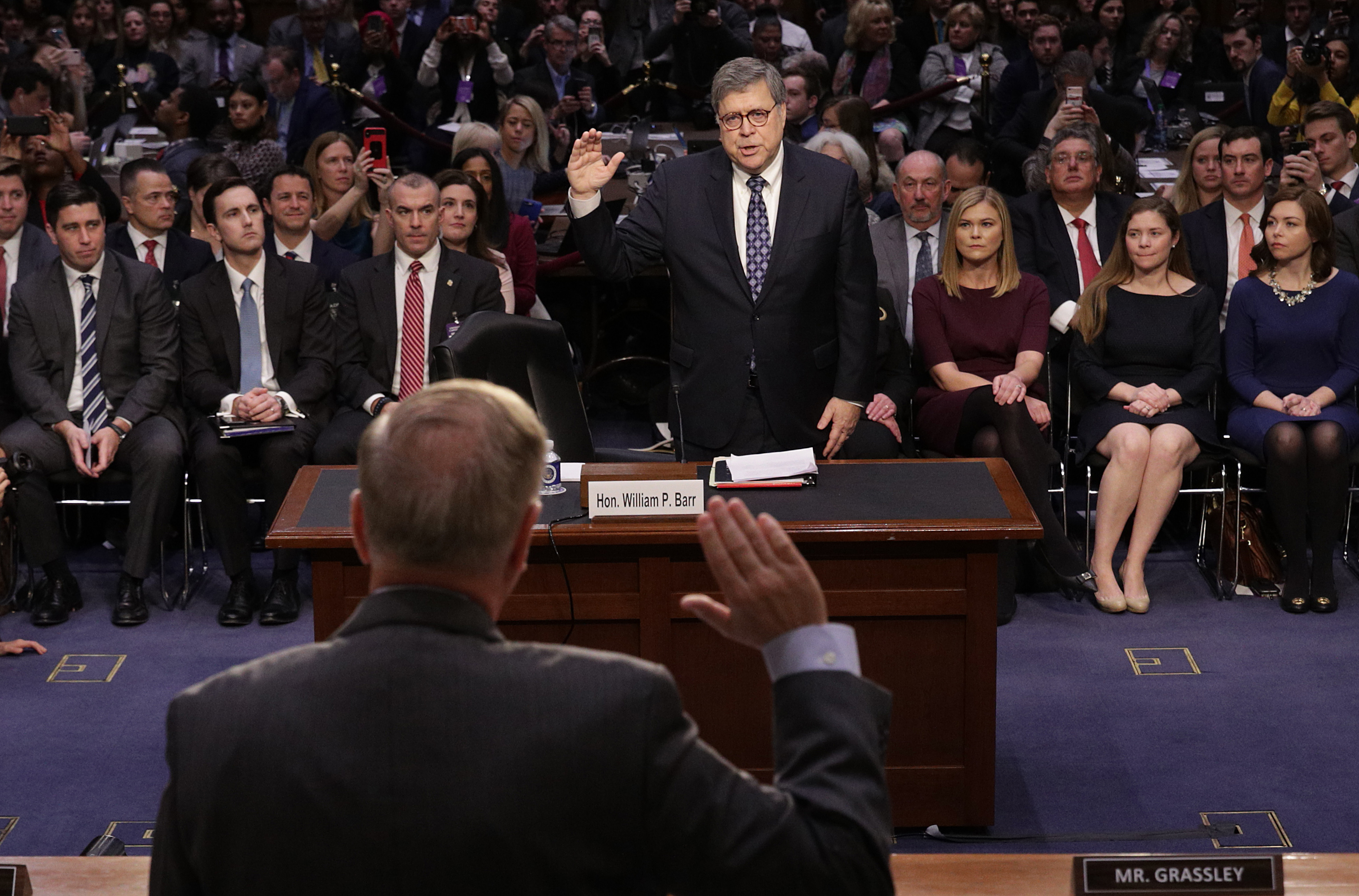 WASHINGTON, DC - JANUARY 15: U.S. Attorney General nominee William Barr (C) is sworn by Senate Judiciary Committee chairman Lindsey Graham (standing) prior to Barr testifying at his confirmation hearing January 15, 2019 in Washington, DC. Barr, who previously served as Attorney General under President George H. W. Bush, was confronted about his views on the investigation being conducted by special counsel Robert Mueller. (Photo by Alex Wong/Getty Images)