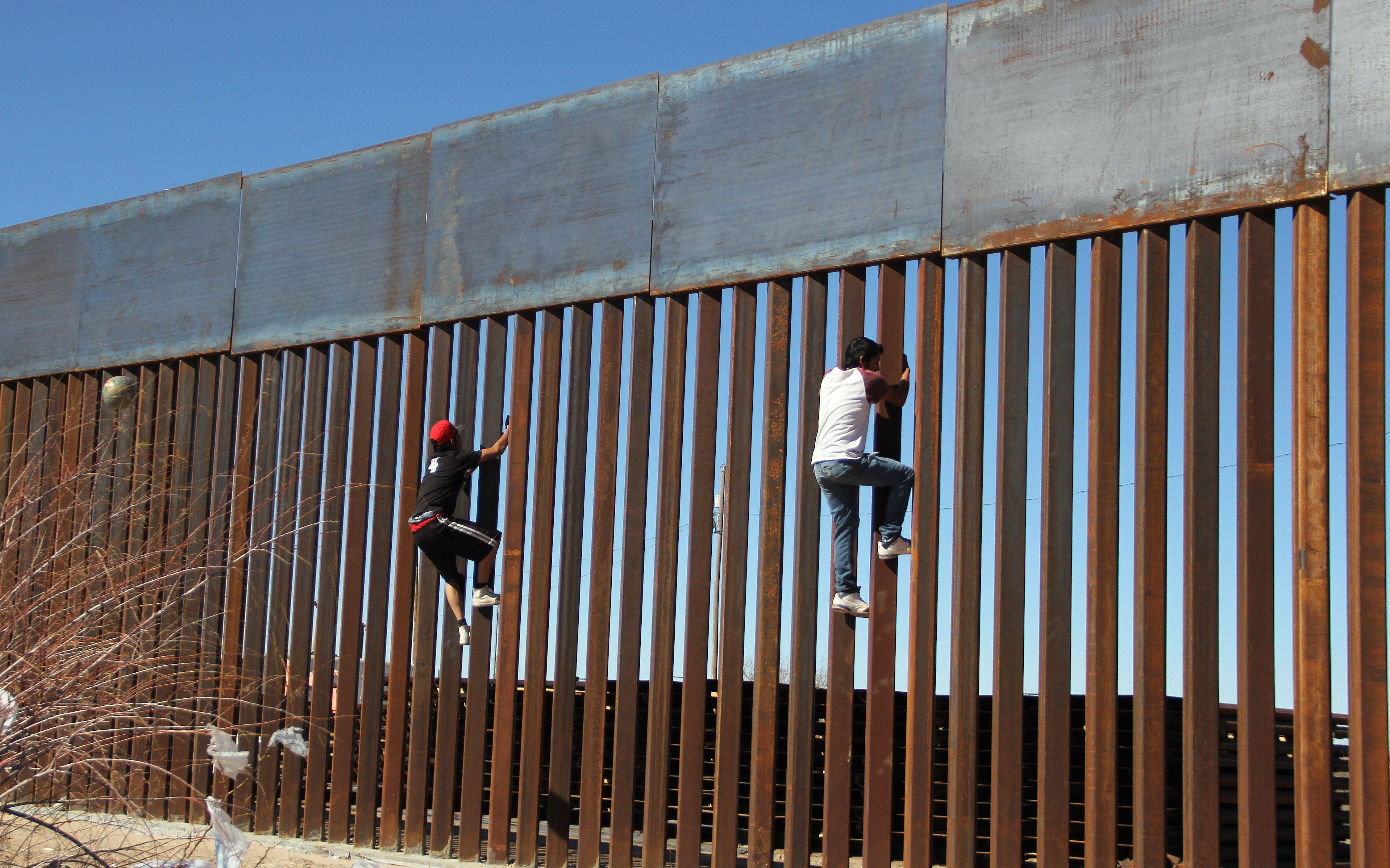 Boys play around, climbing the border division between Mexico and the US in Ciudad Juarez, Mexico on January 26, 2017. US President Donald Trump on Thursday told Mexico's president to cancel an upcoming visit to Washington if he is unwilling to foot the bill for a border wall. Escalating a cross border war of words, Trump took to Twitter to publicly upbraid Enrique Pena Nieto. "If Mexico is unwilling to pay for the badly needed wall, then it would be better to cancel the upcoming meeting." / AFP / HERIKA MARTINEZ (Photo credit should read HERIKA MARTINEZ/AFP/Getty Images)