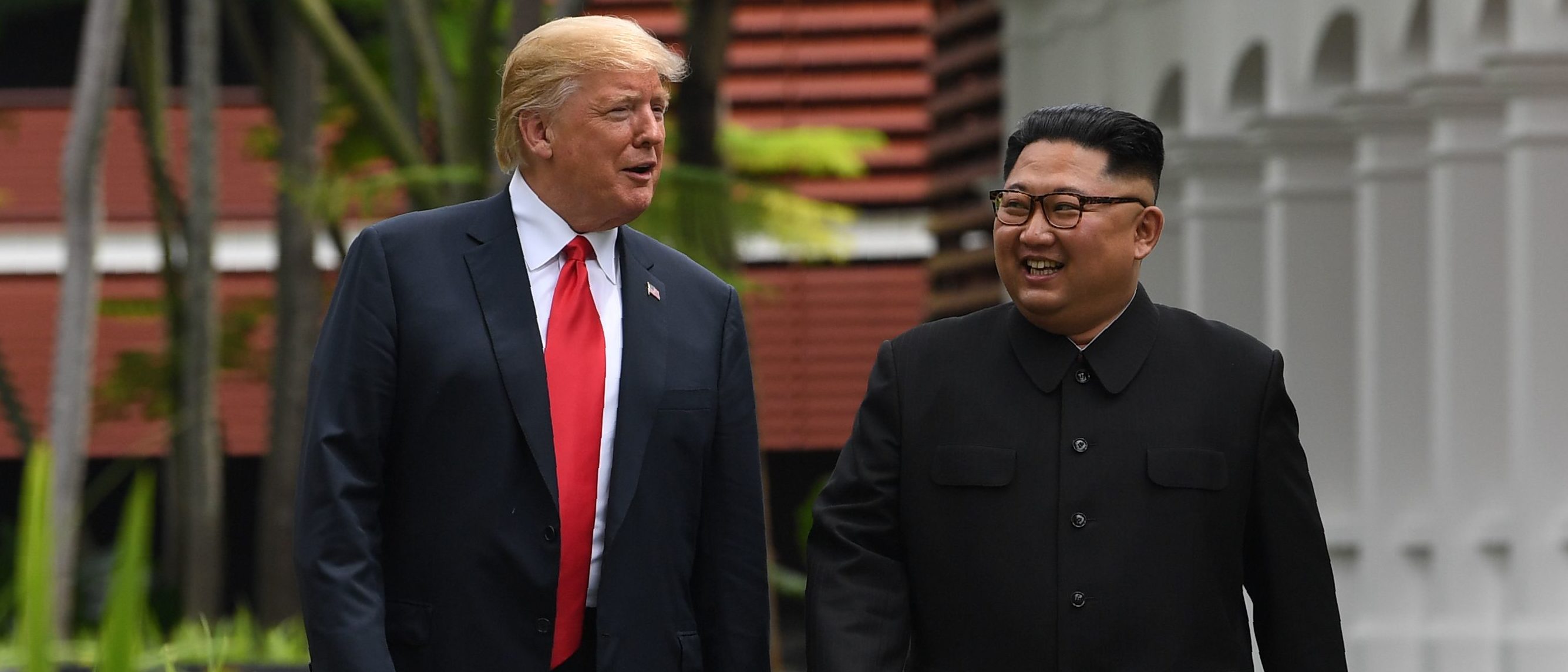 North Korea's leader Kim Jong Un (R) walks with US President Donald Trump (L) during a break in talks at their historic US-North Korea summit, at the Capella Hotel on Sentosa island in Singapore on June 12, 2018. (Photo credit should read SAUL LOEB/AFP/Getty Images)