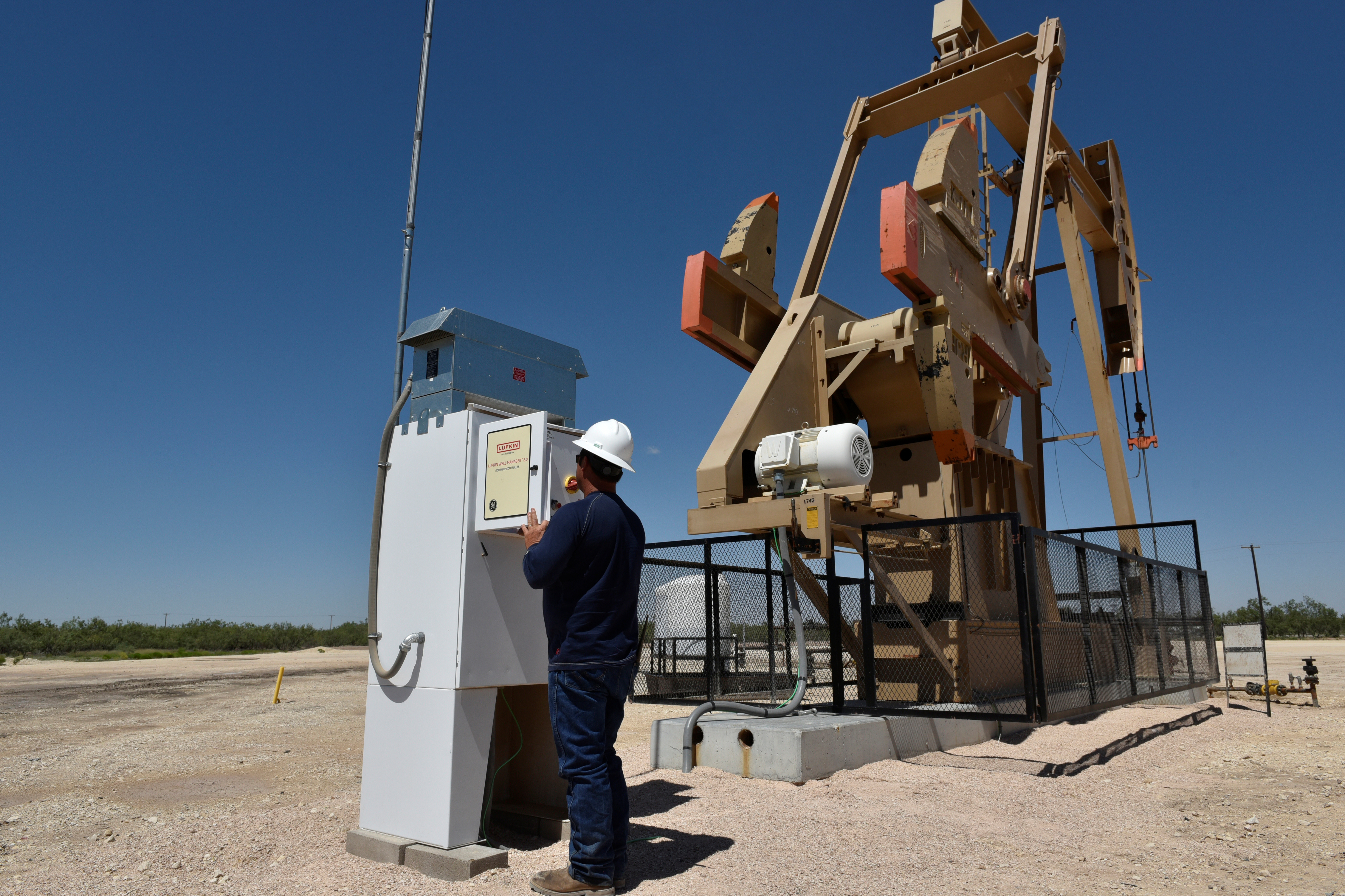 Lease Operator Jon Pearson checks well pressure on a lease owned by Parsley Energy in the Permian Basin near Midland