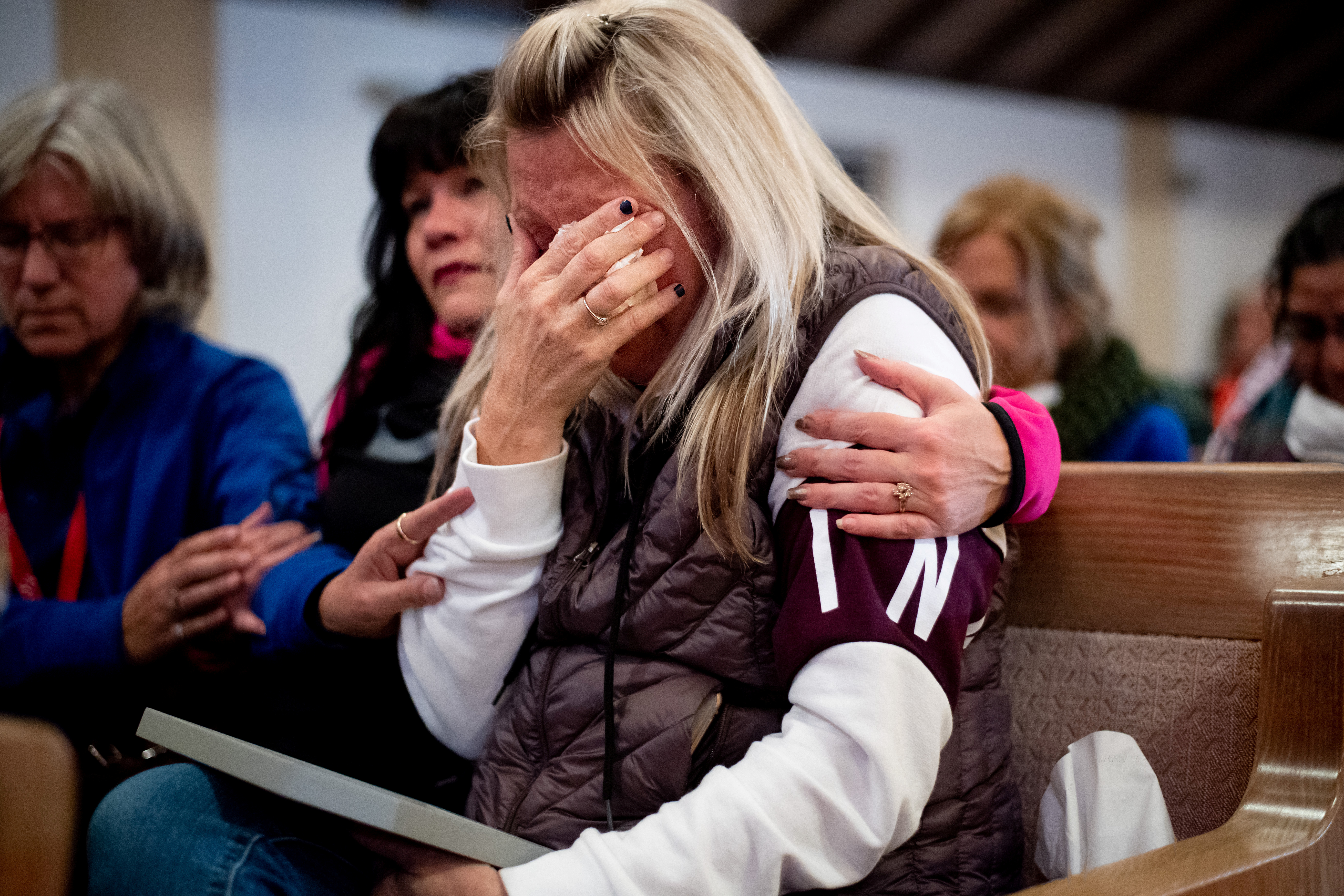 Laura Martin mourns her father, TK Huff, during a vigil for the lives and community lost to the Camp Fire at the First Christian Church of Chico in Chico