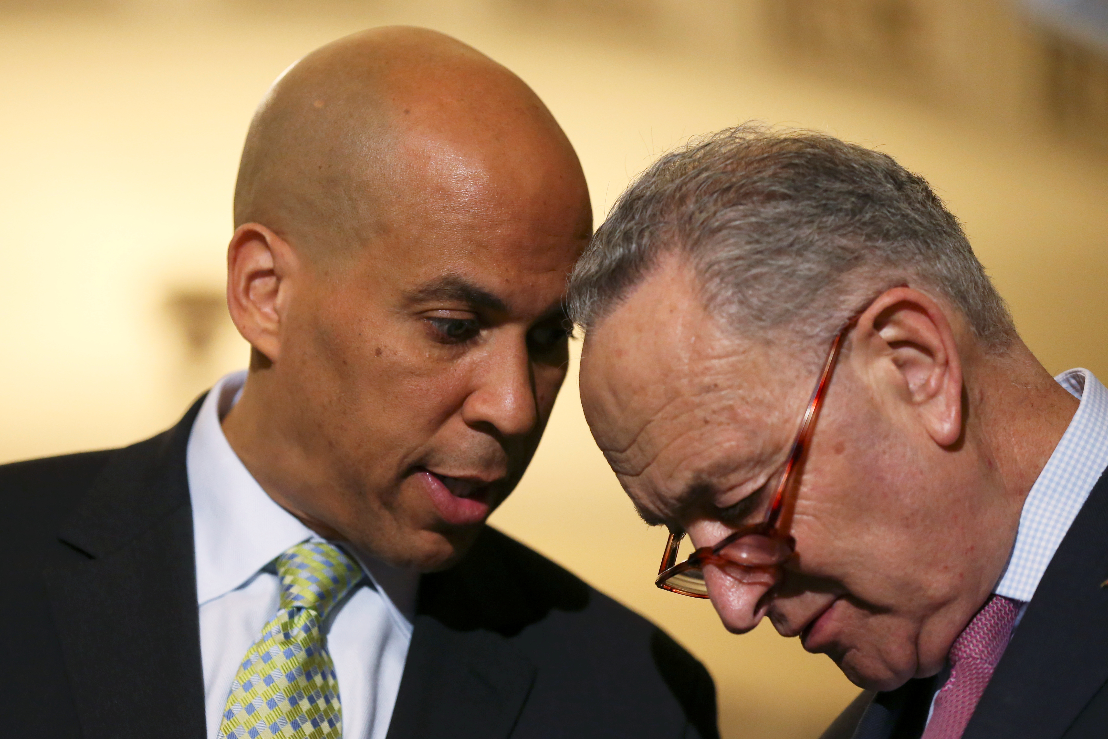 Senator Schumer confers with Booker after Senate Democratic weekly policy lunch on Capitol Hill in Washington