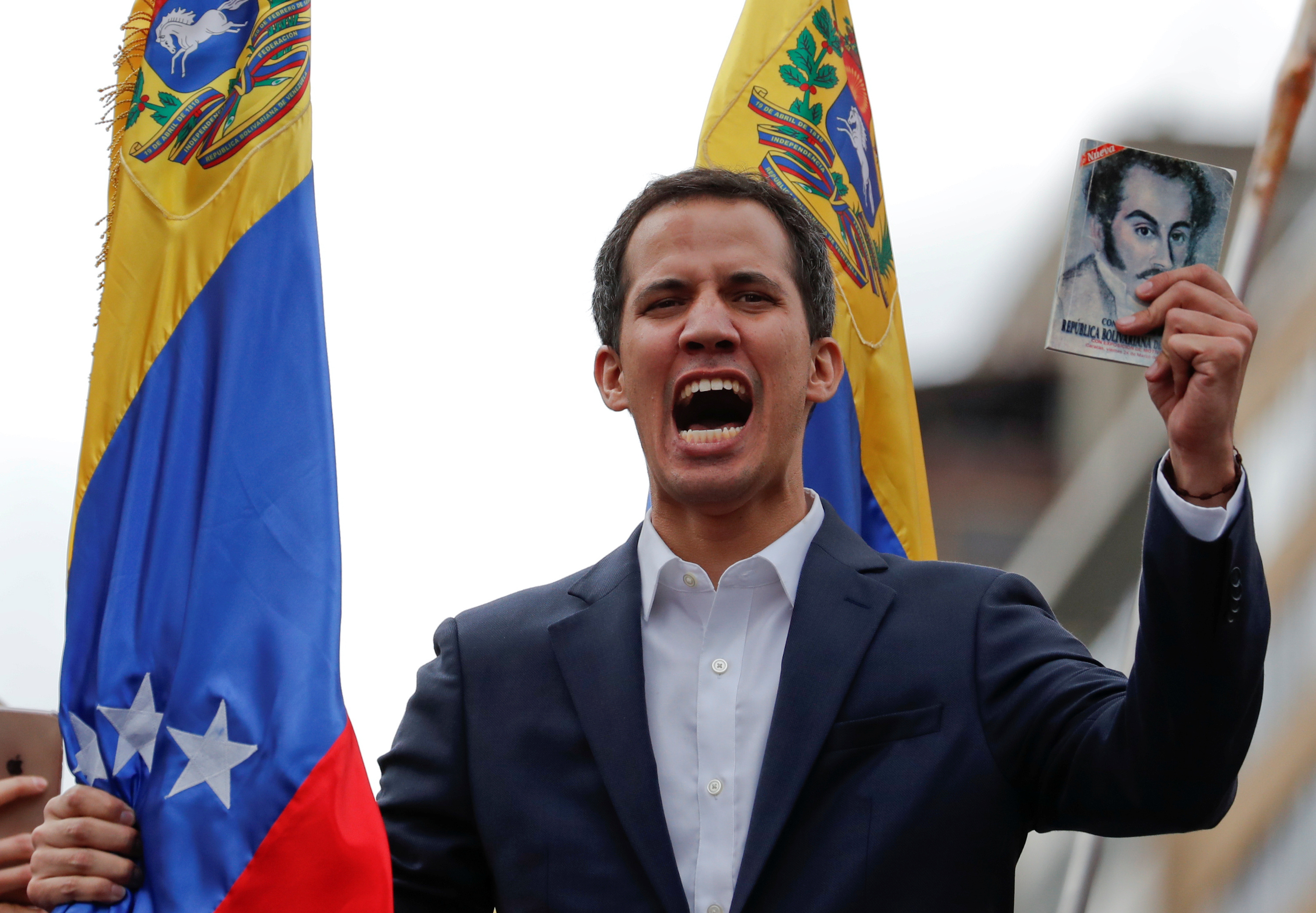 Juan Guaido, President of Venezuela's National Assembly, holds a copy of Venezuelan constitution during a rally against Venezuelan President Nicolas Maduro's government and to commemorate the 61st anniversary of the end of the dictatorship of Marcos Perez Jimenez in Caracas, Venezuela January 23, 2019. REUTERS/Carlos Garcia Rawlins