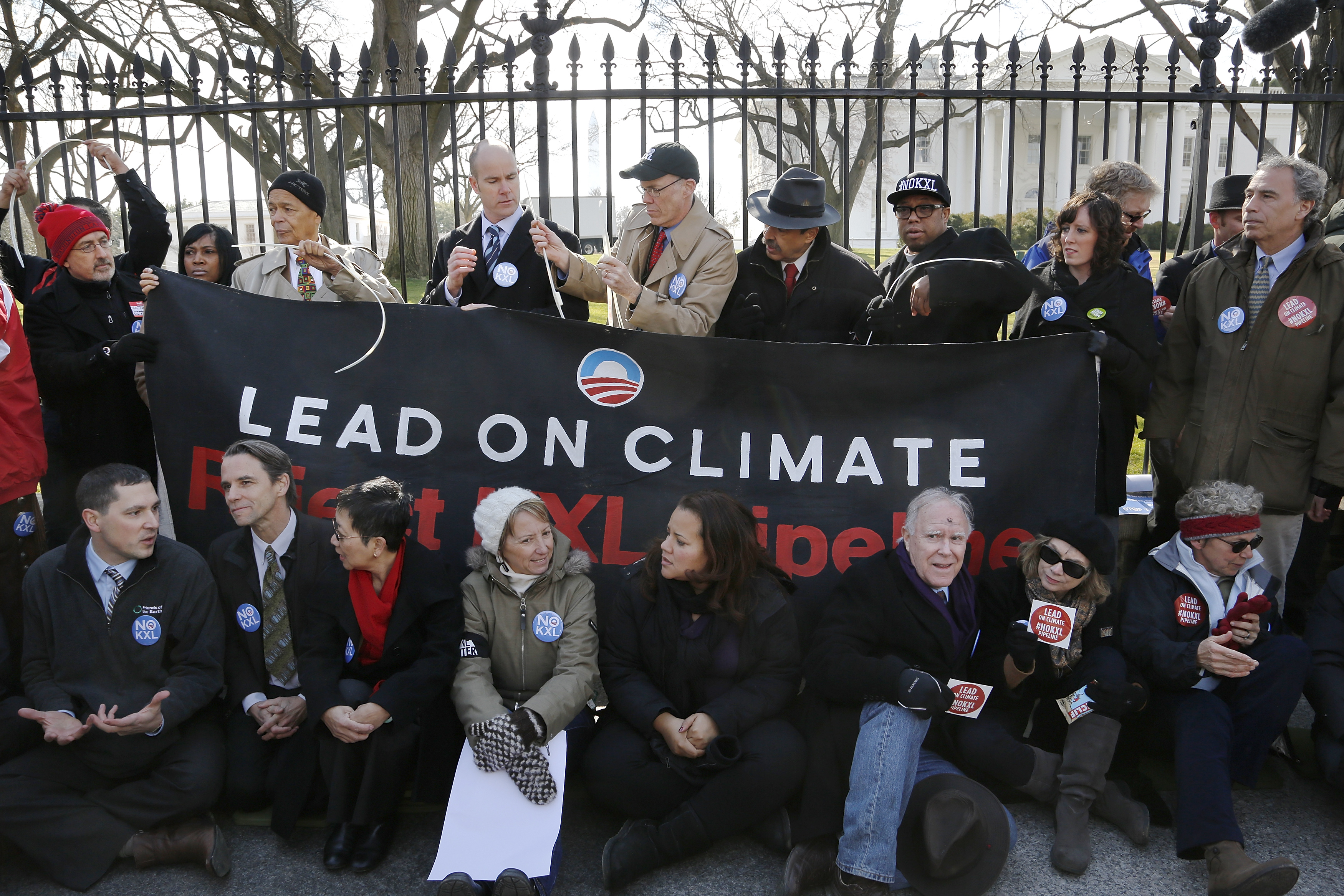 Activists opposed to the Keystone XL tar sands pipeline project tie themselves to the White House fence during an environmental protest in Washington