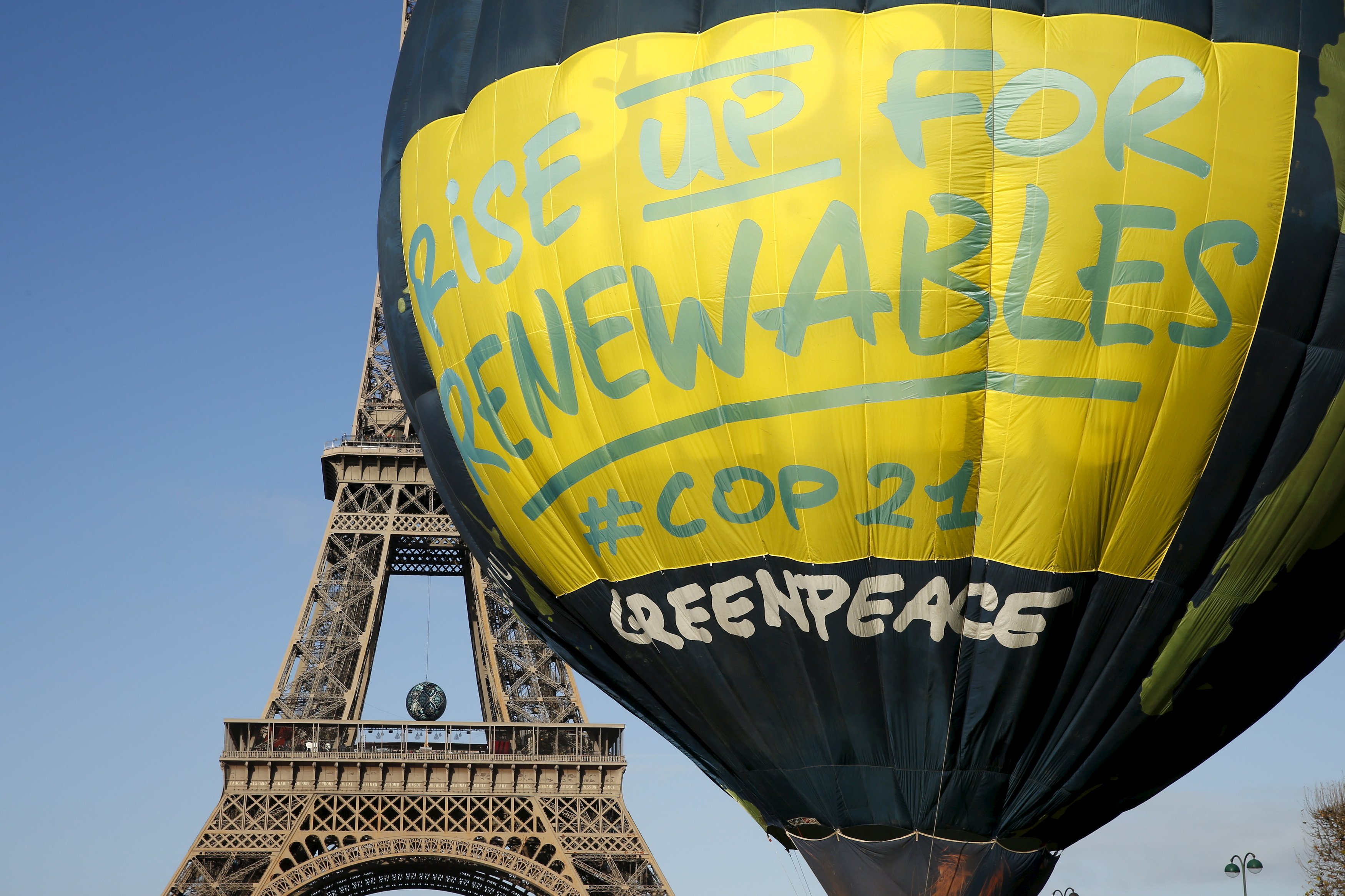 Greenpeace activists fly a hot air balloon depicting the globe next to the Eiffel Tower ahead of the 2015 Paris Climate Conference, known as the COP21 summit, in Paris