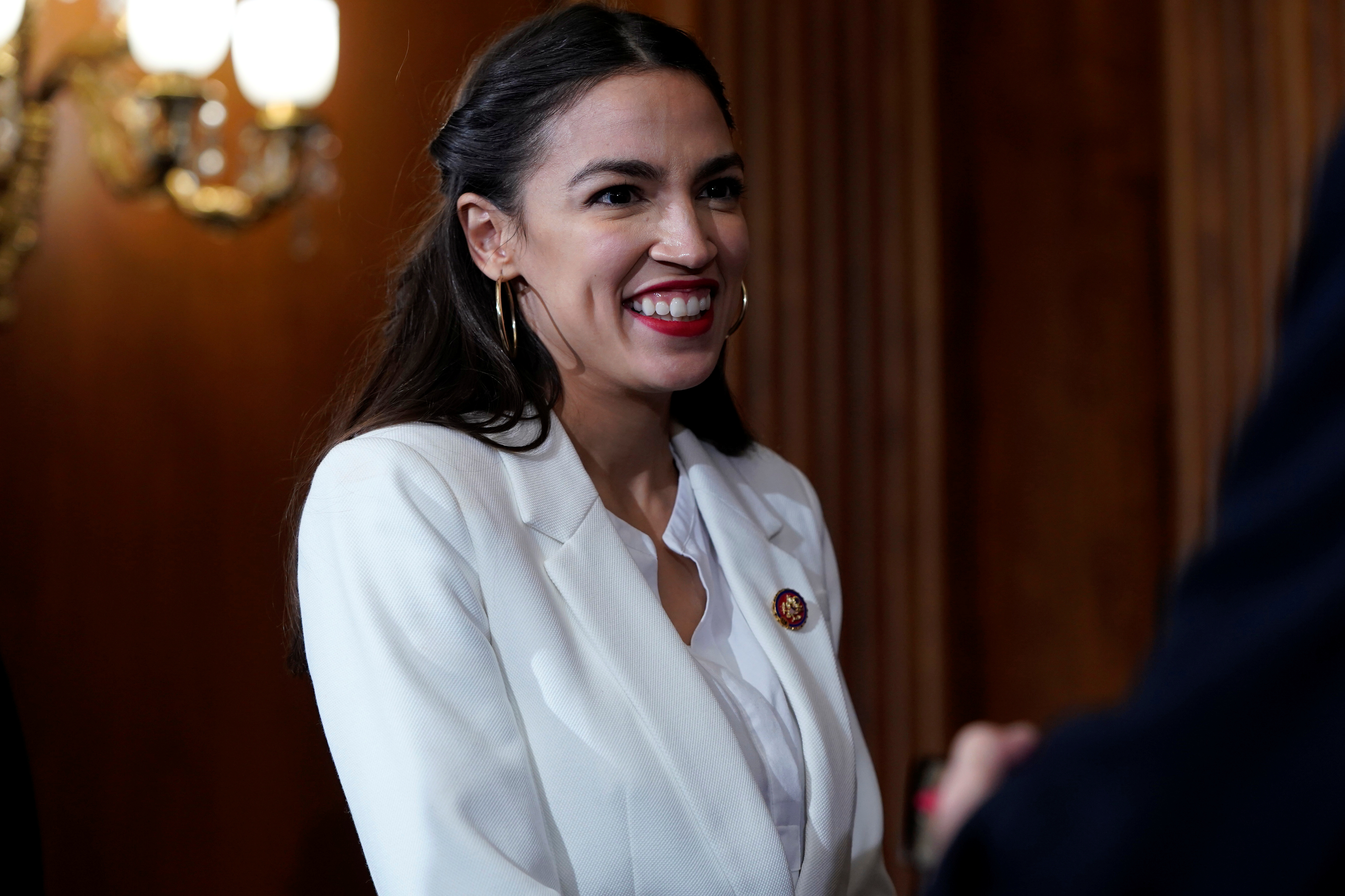 Rep. Alexandria Ocasio-Cortez (D-NY) waits for a ceremonial swearing-in picture on Capitol Hill in Washington