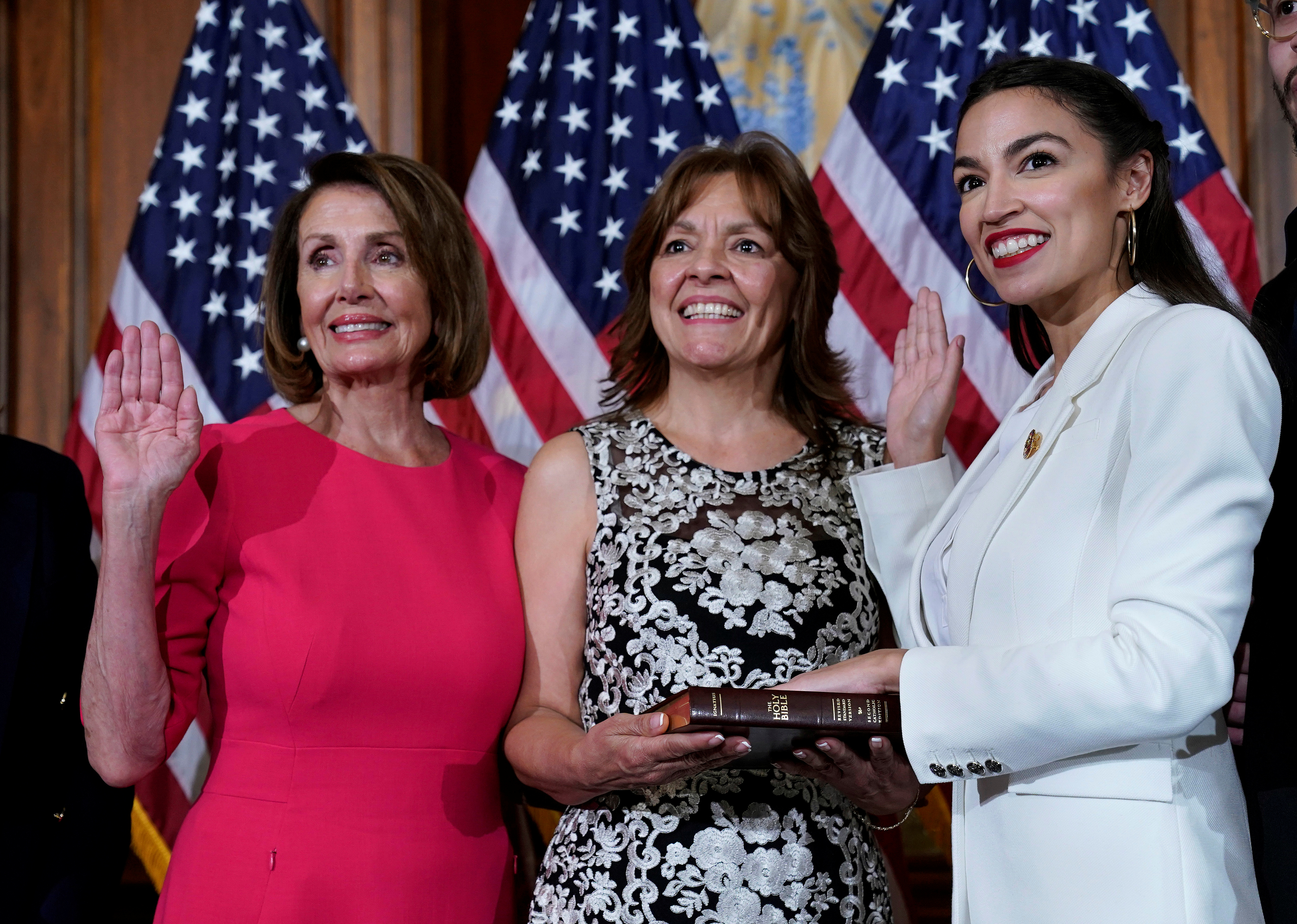 Rep. Alexandria Ocasio-Cortez (D-NY) poses with Speaker of the House Nancy Pelosi (D-CA) for a ceremonial swearing-in picture on Capitol Hill in Washington
