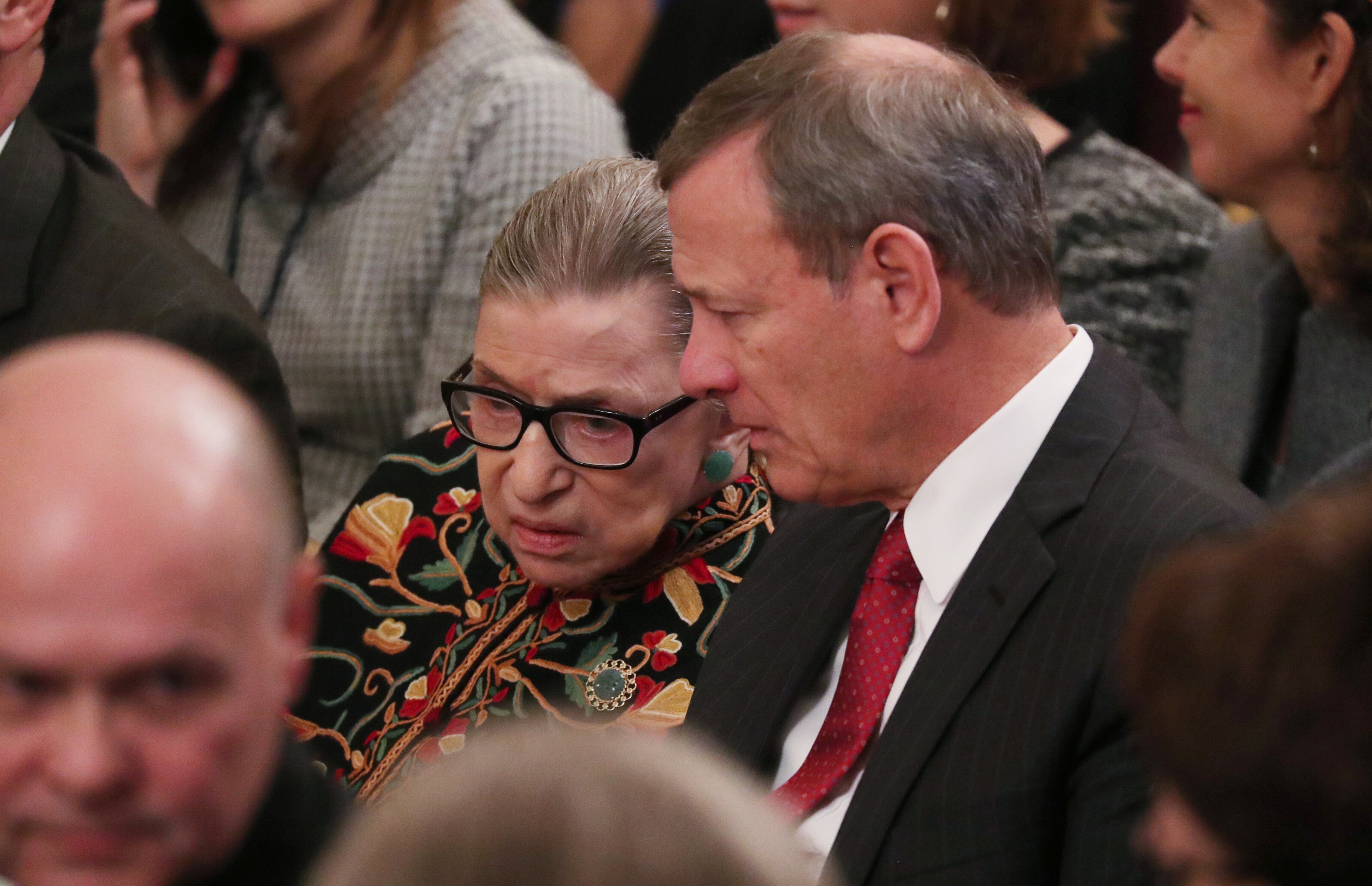 Justice Ruth Bader Ginsburg talks with Chief Justice John Roberts as they attend a ceremony with President Donald Trump awarding the 2018 Presidential Medals of Freedom at the White House on November 16, 2018. REUTERS/Jonathan Ernst