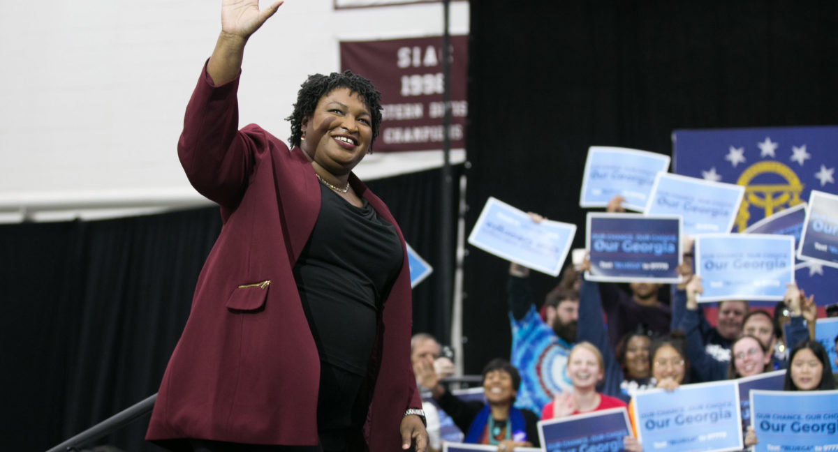 Georgia Democratic Gubernatorial candidate Stacey Abrams walks on stage and waves at the audience for a campaign rally at Morehouse College with Former US President Barack Obama on Nov. 2, 2018 in Atlanta, Georgia. (Photo by Jessica McGowan/Getty Images)
