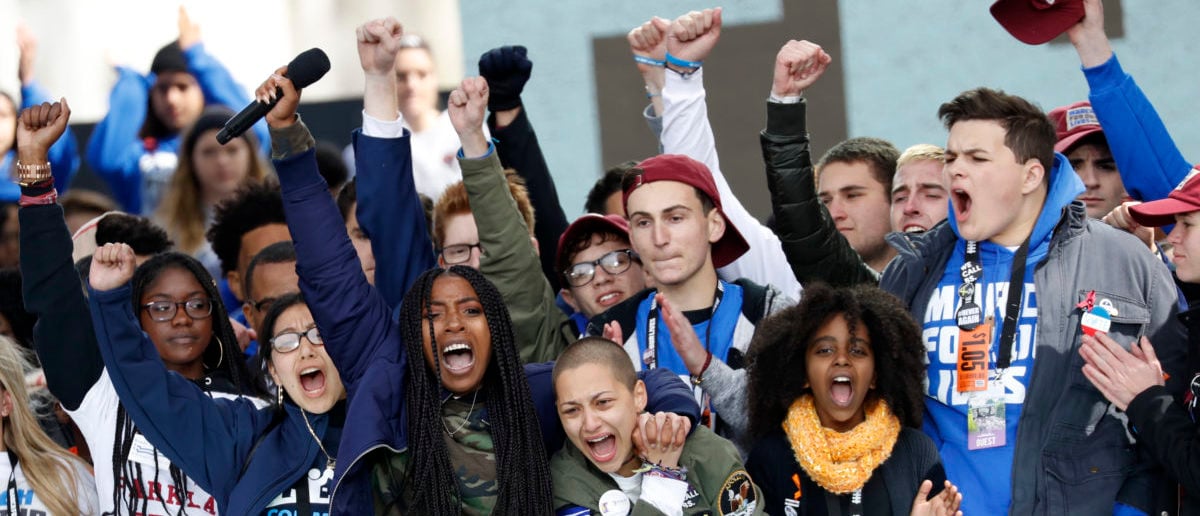 Students and shooting survivors Tyra Hemans and Emma Gonzalez (3rd from R), from Marjory Stoneman Douglas High School in Parkland, Florida, and 11-year-old Naomi Wadler of Alexandria, Virginia (2nd from R), sing along with other students and shooting survivors at the conclusion of the "March for Our Lives" event demanding gun control after recent school shootings at a rally in Washington, U.S., March 24, 2018. REUTERS/Aaron P. Bernstein