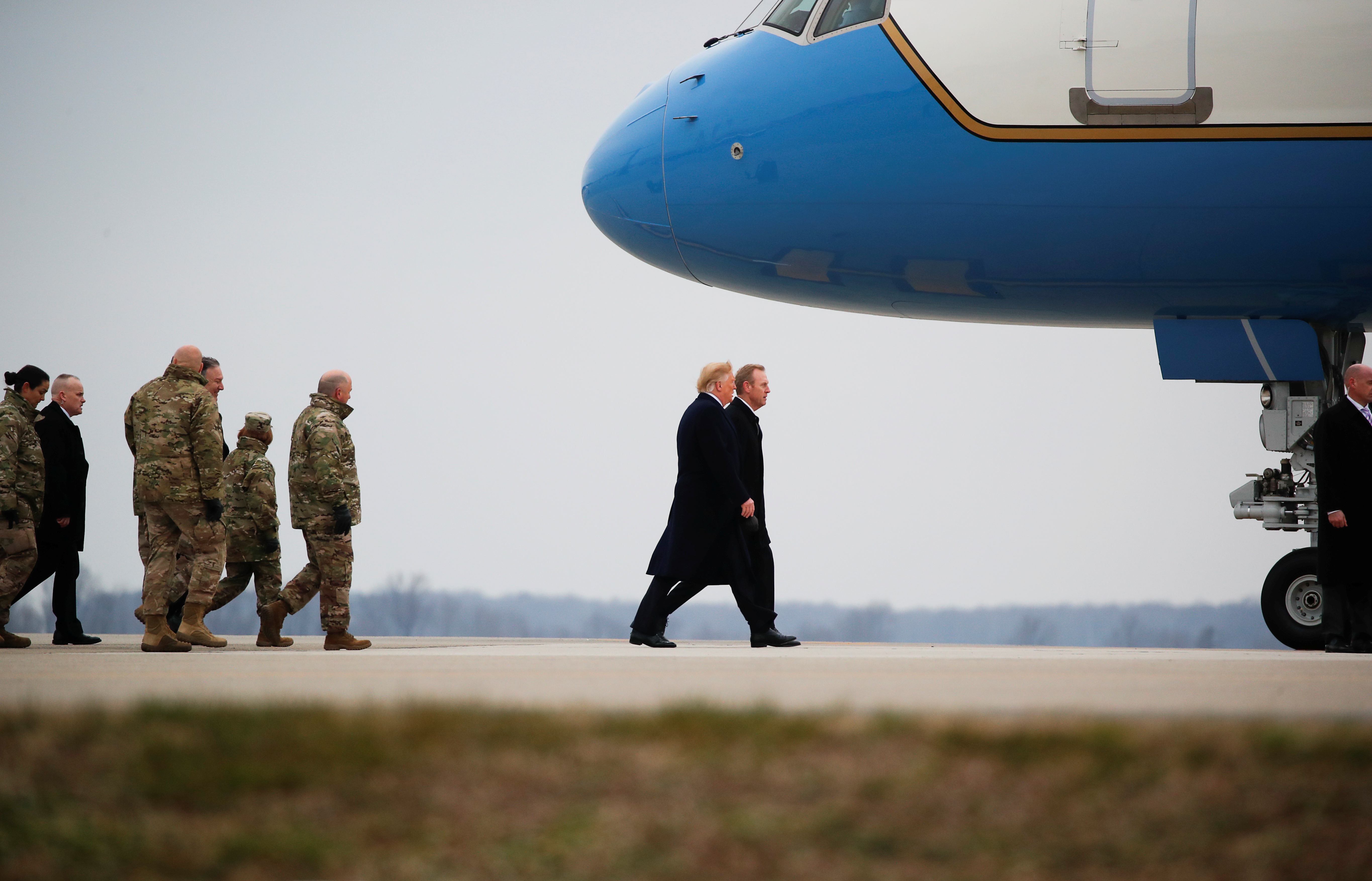 U.S. President Donald Trump walks back to Air Force One with acting Secretary of Defnese Patrick Shanahan after dignified transfer ceremonies for three members of the U.S. military and one civilian employee of the Defense Intelligence Agency killed during a recent attack in Syria, as they prepare to depart Dover Air Force Base, in Dover, Delaware, U.S., January 19, 2019. REUTERS/Carlos Barria