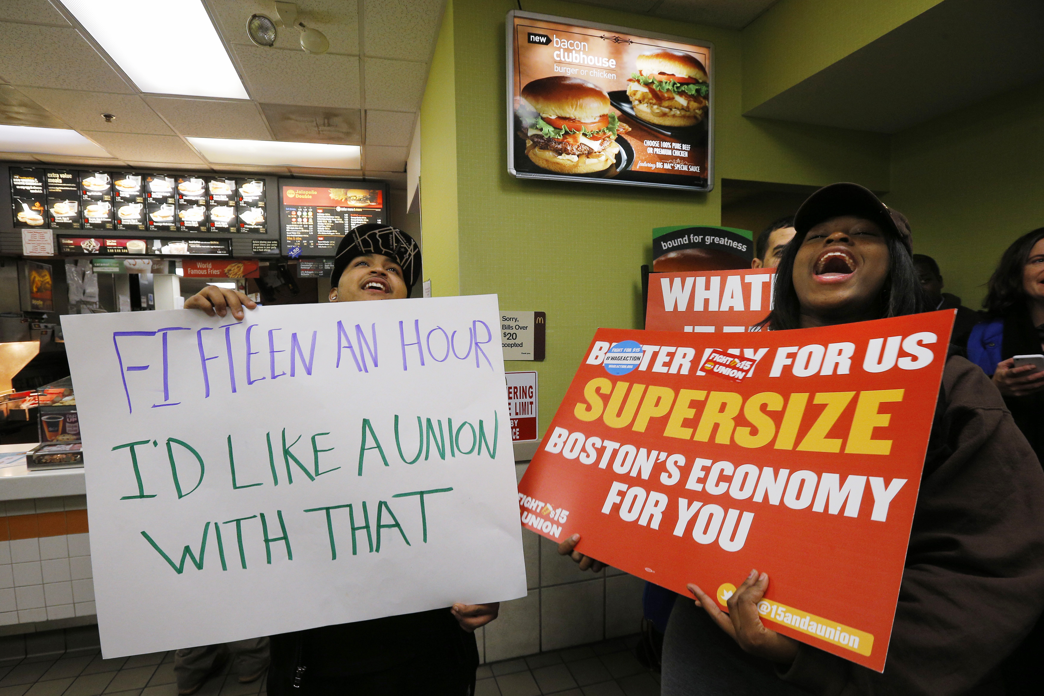 Scores of fast food workers and their supporters calling for a $15 minimum wage fill a McDonalds restaurant in Chelsea, Massachusetts December 4, 2014. Workers in the fast-food, home care and airline industries are staging protests and strikes throughout the United States on Thursday to advocate for a $15 minimum wage and other labor rights. The protests are under a banner organization called "Fight for 15" and organizers say they expect Thursday's actions will represent the most expansive to date, increasing to a planned 160 cities from 150 in a similar nationwide protest in early September. REUTERS/Brian Snyder