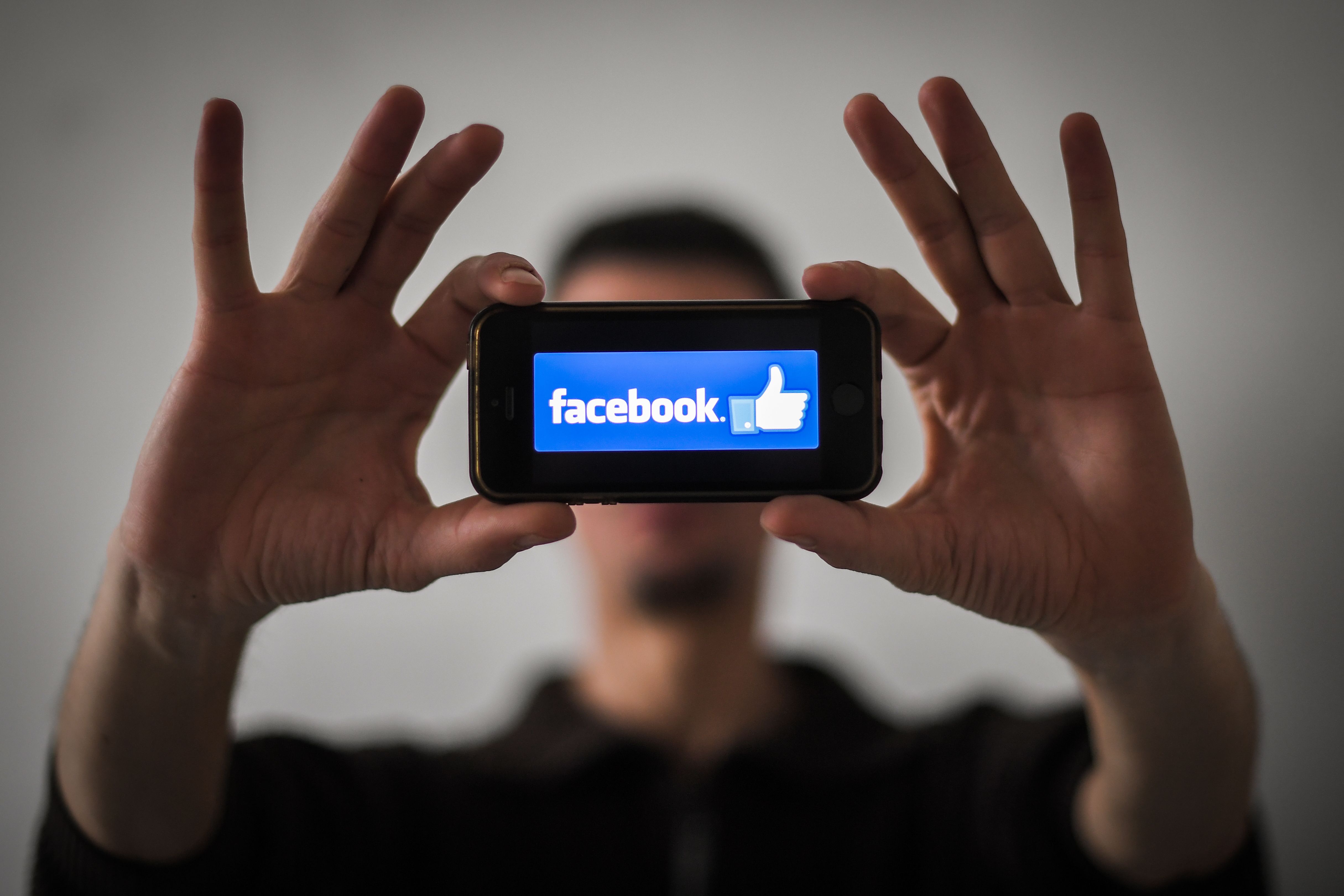 A man shows the logo of social network Facebook displayed on a smartphone, on January 15, 2019 in Nantes, western France. (LOIC VENANCE/AFP/Getty Images)