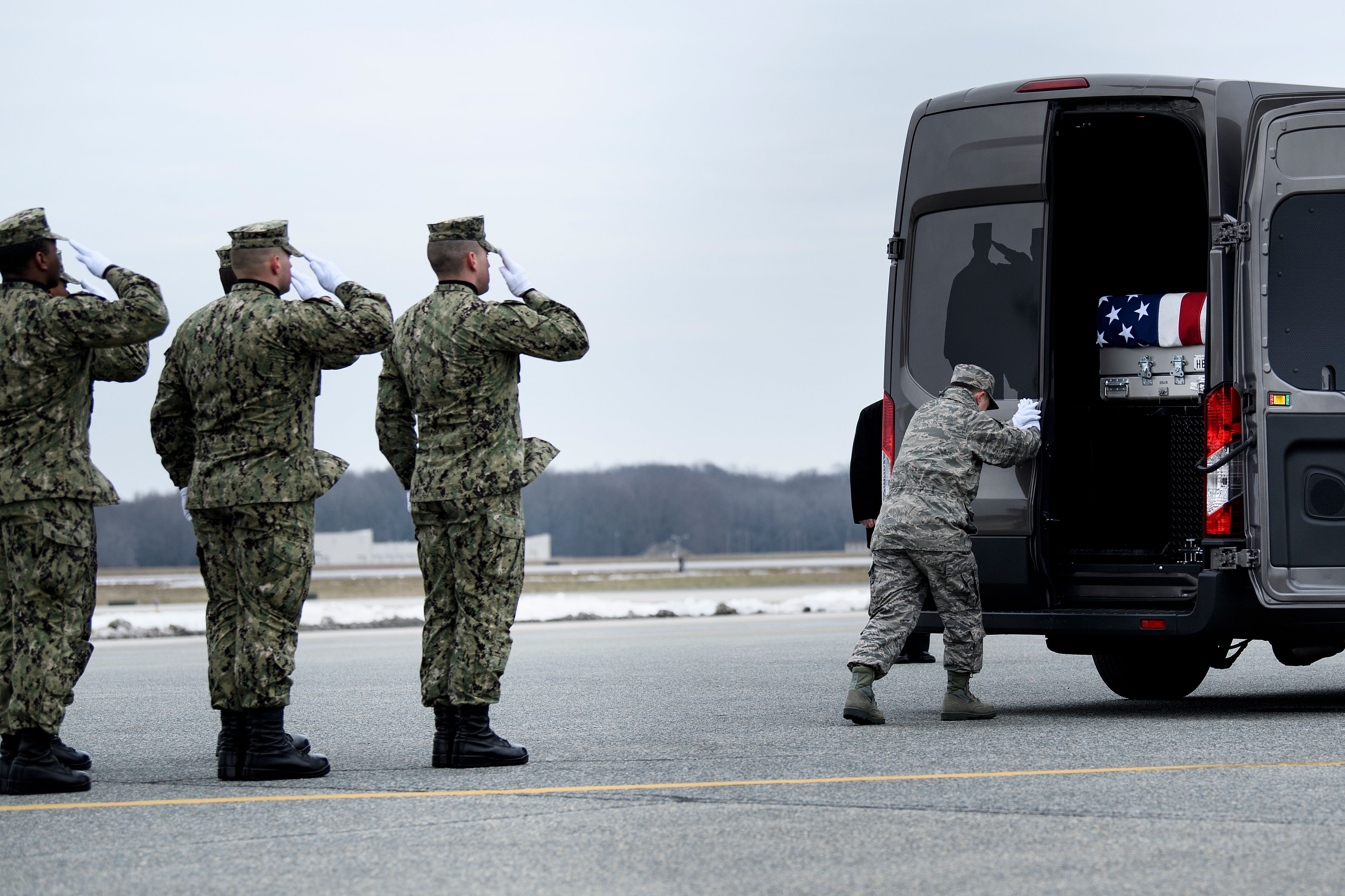 A member of the Air Force secures the remains of Scott A. Wirtz, a Defense Intelligence Agency civilian and former Navy Seal, in a vehicle during a dignified transfer for US personal killed in a suicide bombing in Syria, at Dover Air Force Base January 19, 2019 in Dover, Delaware. (BRENDAN SMIALOWSKI/AFP/Getty Images)