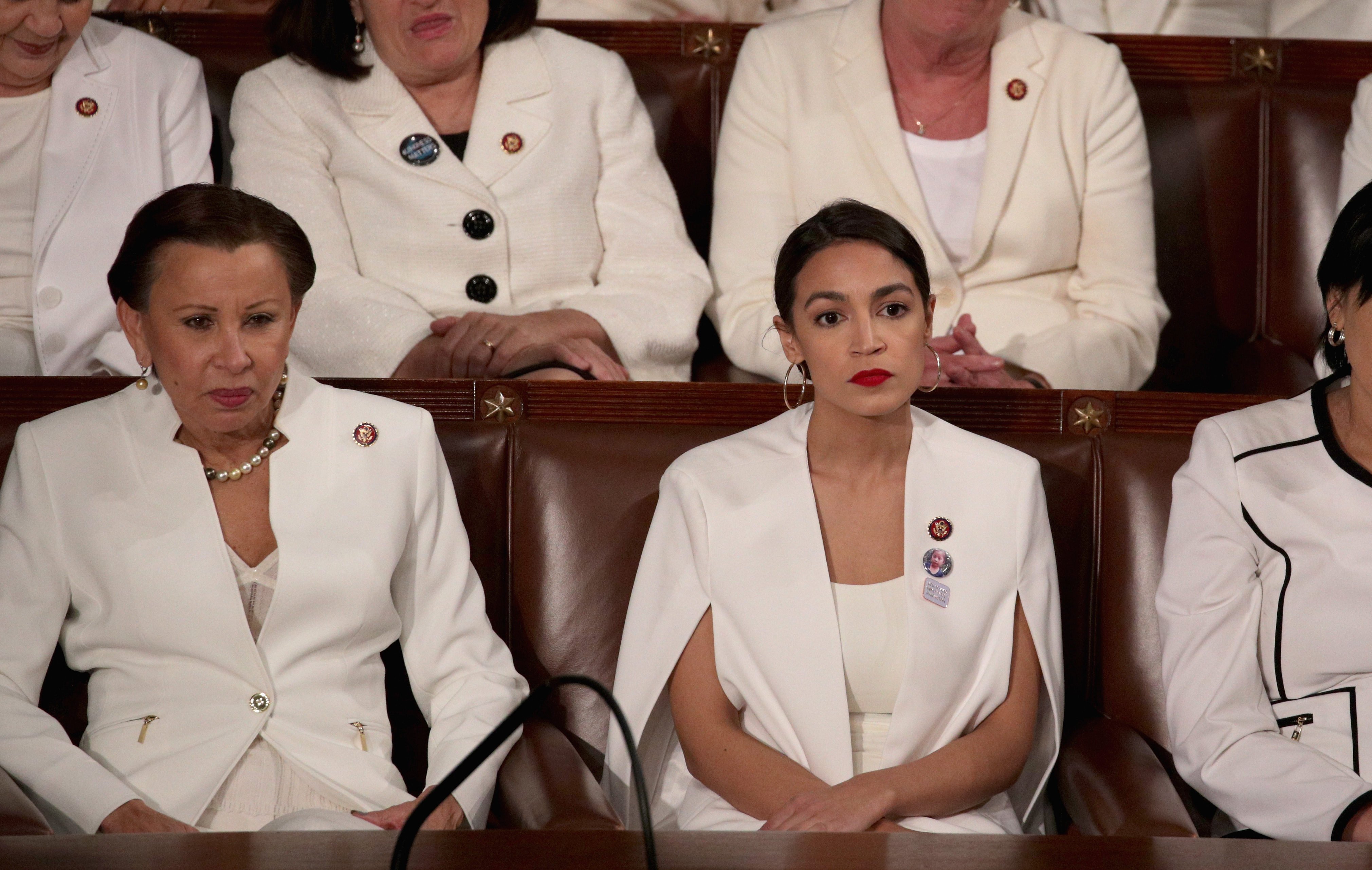 (L to R) Rep. Nydia Velazquez and Rep. Alexandria Ocasio-Cortez watch President Donald Trump's State of the Union address in the chamber of the U.S. House of Representatives at the U.S. Capitol Building on February 5, 2019 in Washington, DC. (Photo by Alex Wong/Getty Images)