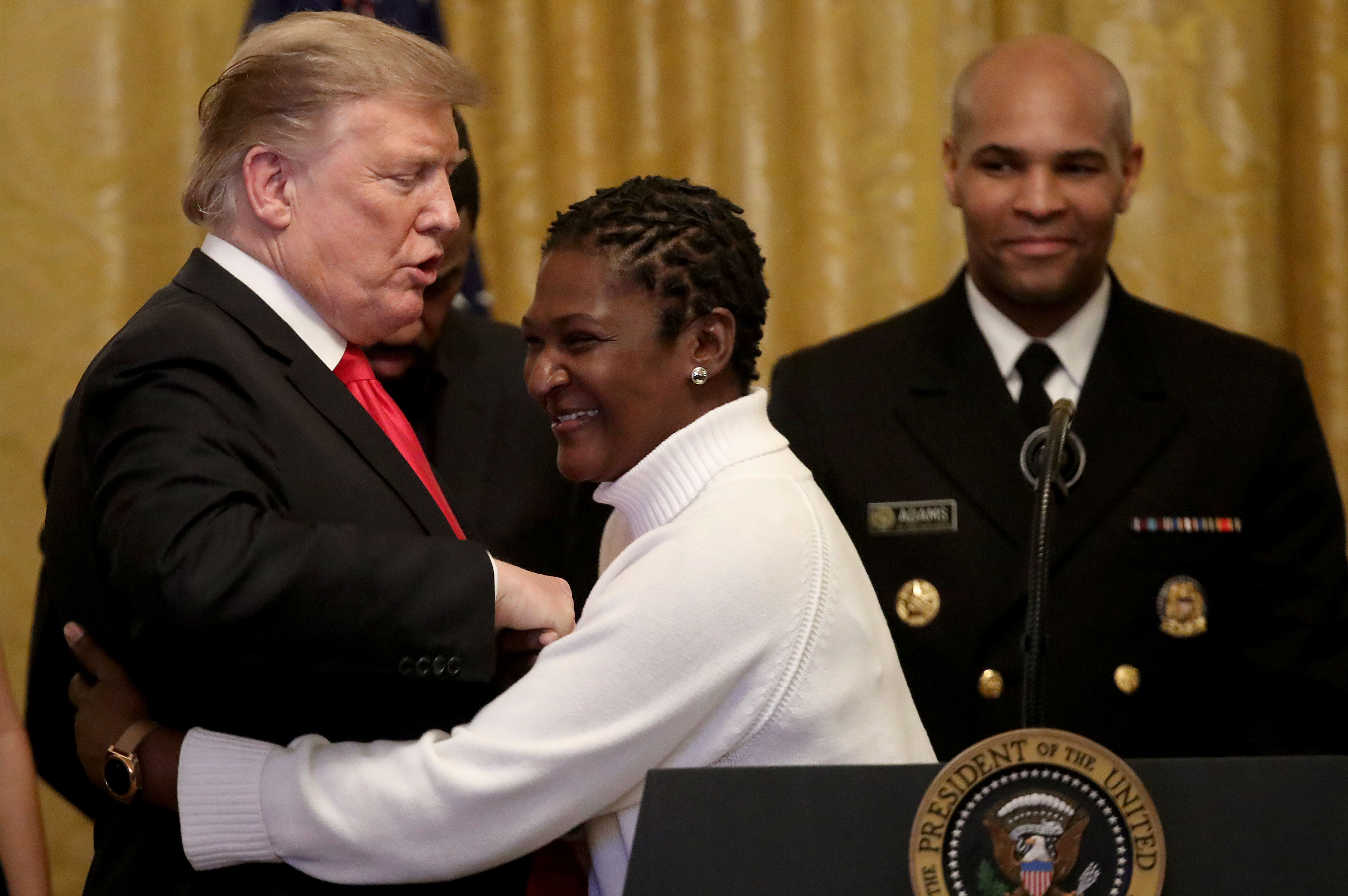 WASHINGTON, DC - FEBRUARY 21: U.S. President Donald Trump is hugged by Catherine Toney, a former inmate released following passage of the prison reform First Step Act, during a reception in the East Room of the White House February 21, 2019 in Washington, DC. The reception was held in honor of National African American History Month. (Photo by Win McNamee/Getty Images)