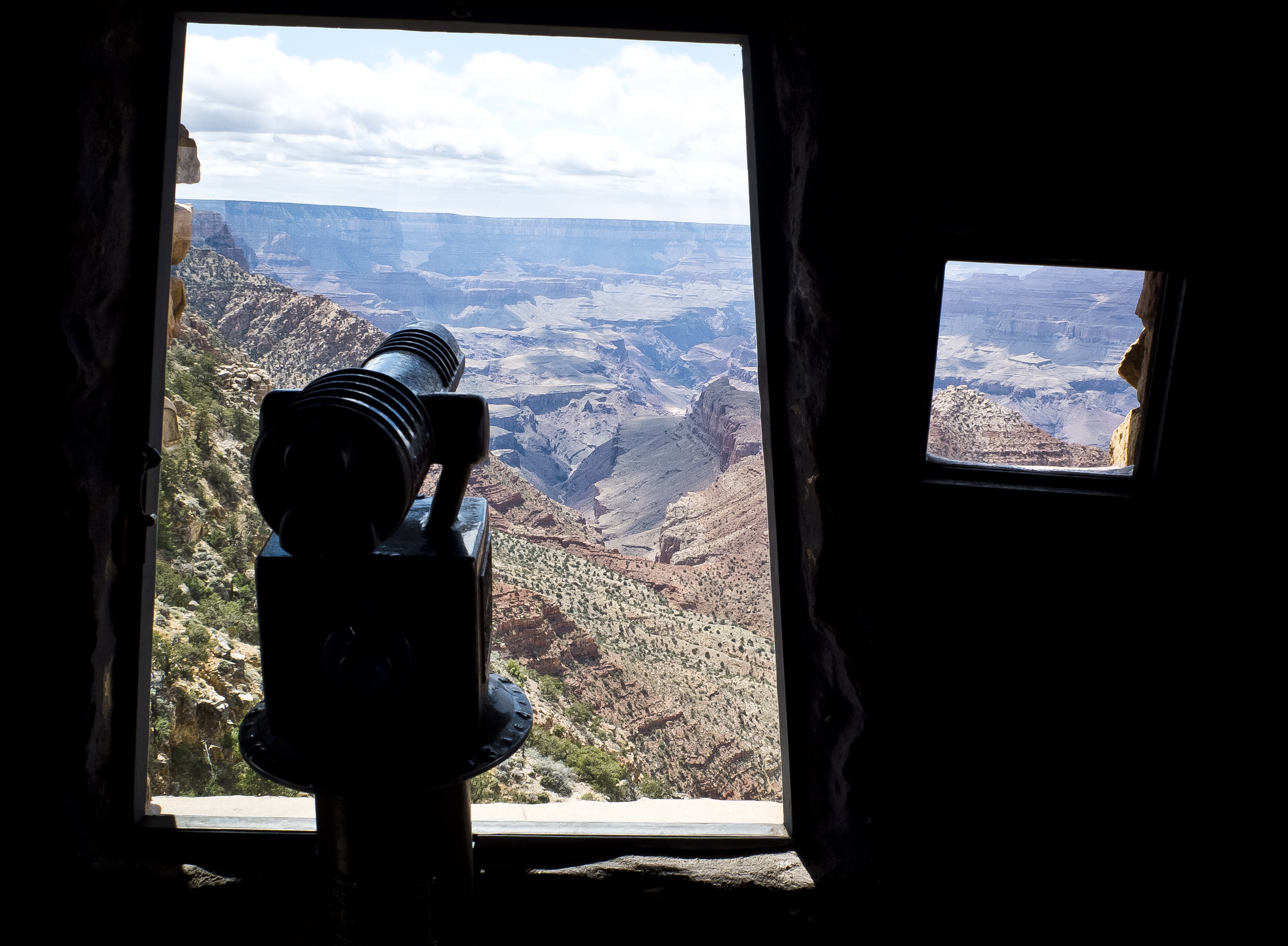 A coin viewer points at the Grand Canyon trough a window of the Desert View Watchtower, built at the edge of the canyon South Rim in Arizona on May 11, 2014. (MLADEN ANTONOV/AFP/Getty Images)