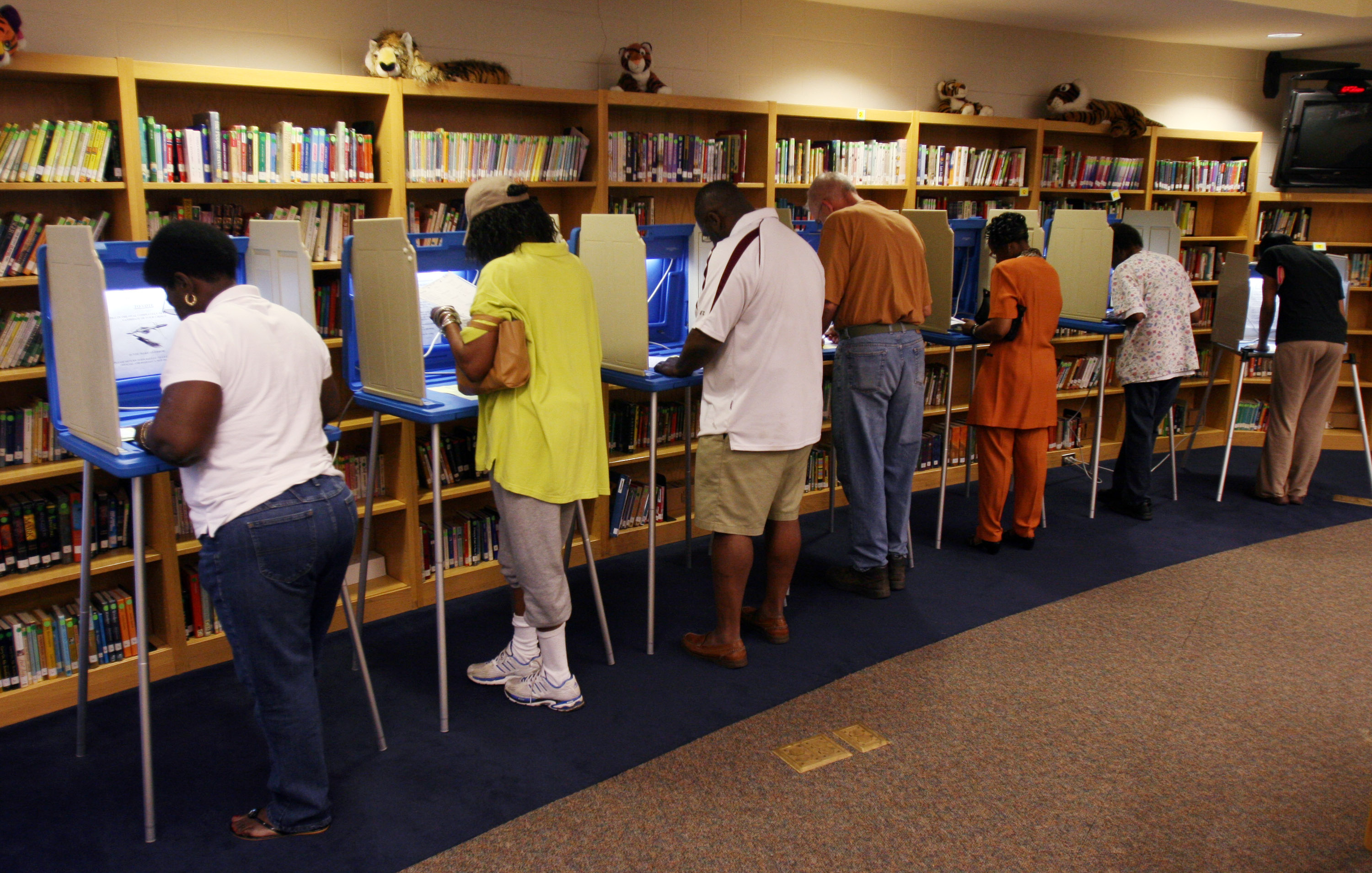 WILMINGTON, NC - MAY 6: Voters cast their ballots at the Williston Middle School polling station the morning of May 6, 2008 in Wilmington, North Carolina. Voters in Indiana and North Carolina have their primary polls May 6. (Photo by Logan Mock-Bunting/Getty Images)