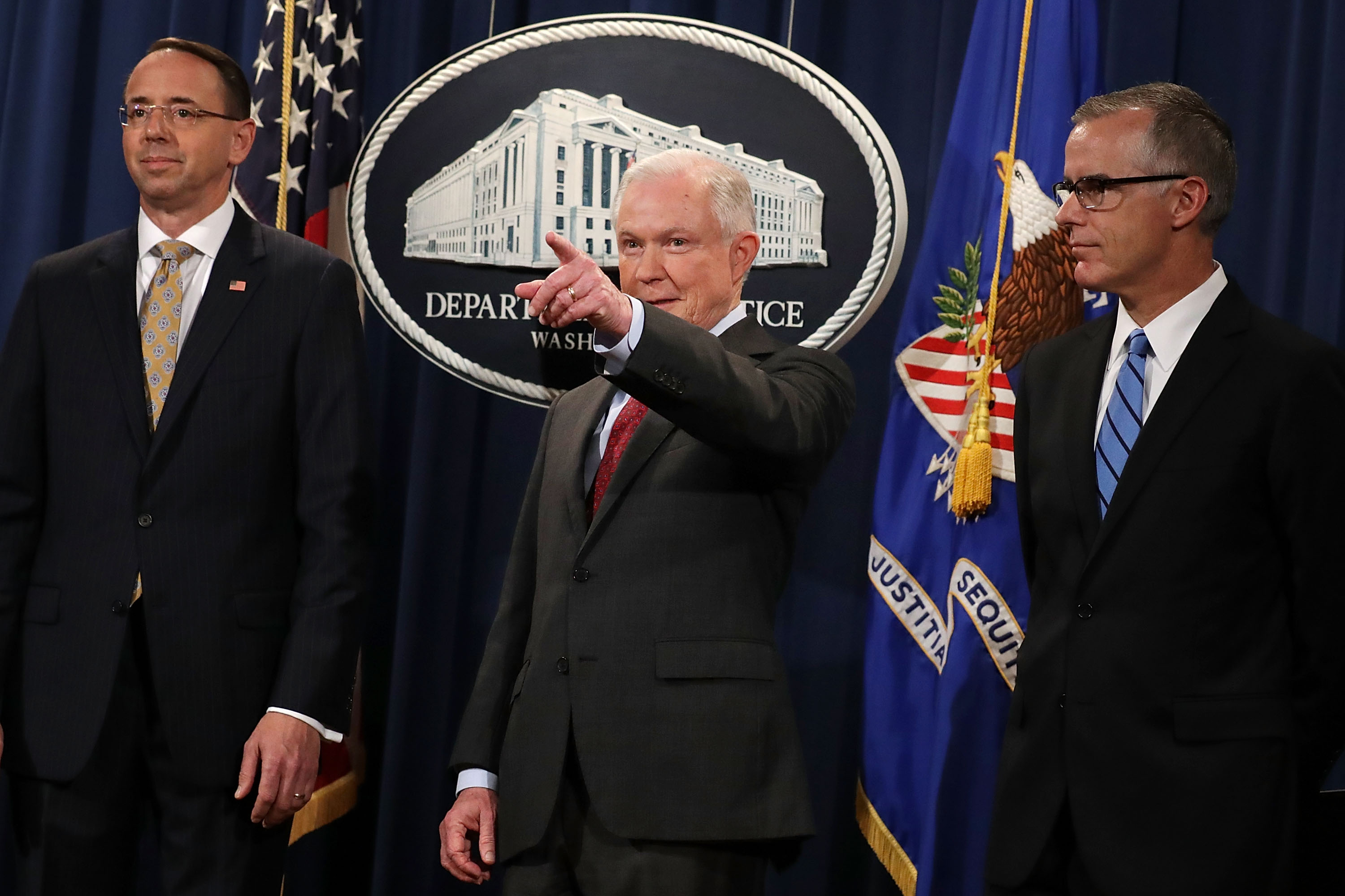 (L-R) Deputy Attorney General Rod Rosenstein, U.S. Attorney General Jeff Sessions, Acting FBI Director Andrew McCabe other law enforcement officials hold a news conference to announce an 'international cybercrime enforcement action' at the Department of Justice July 20, 2017 in Washington, DC. (Photo by Chip Somodevilla/Getty Images)