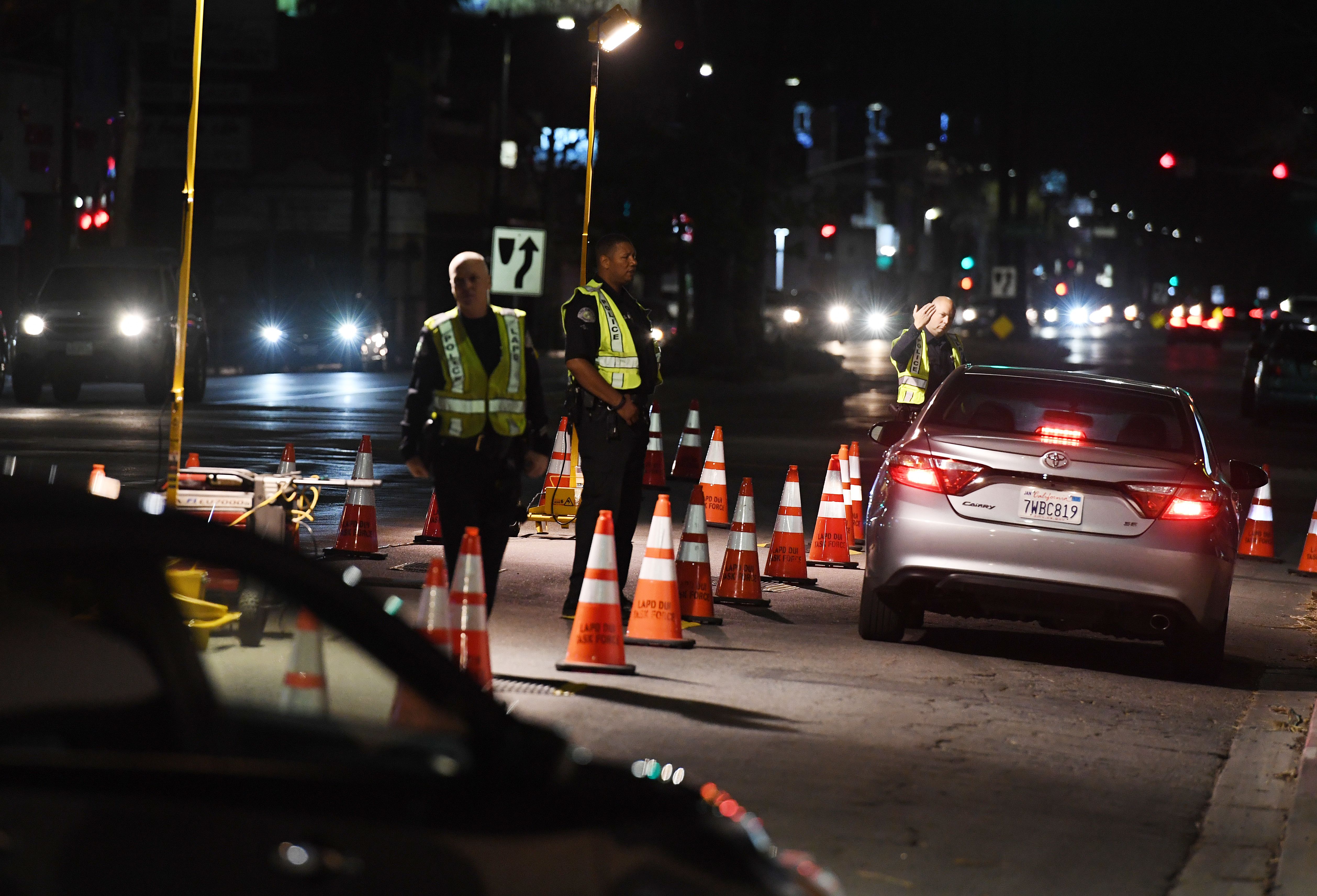 LAPD police check drivers at a DUI checkpoint in Reseda, Los Angeles, California on April 13, 2018. (MARK RALSTON/AFP/Getty Images)